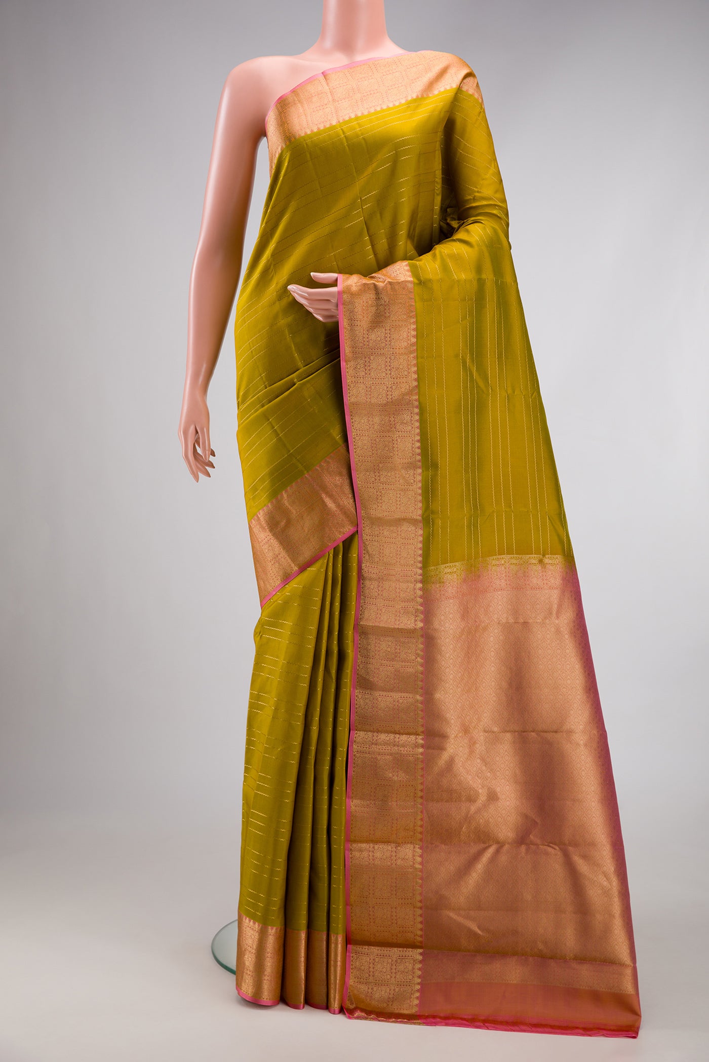 Mehandi Green Kanchipuram Silk Saree with Veldhari on the body and Zari Border.  displayed on a mannequin