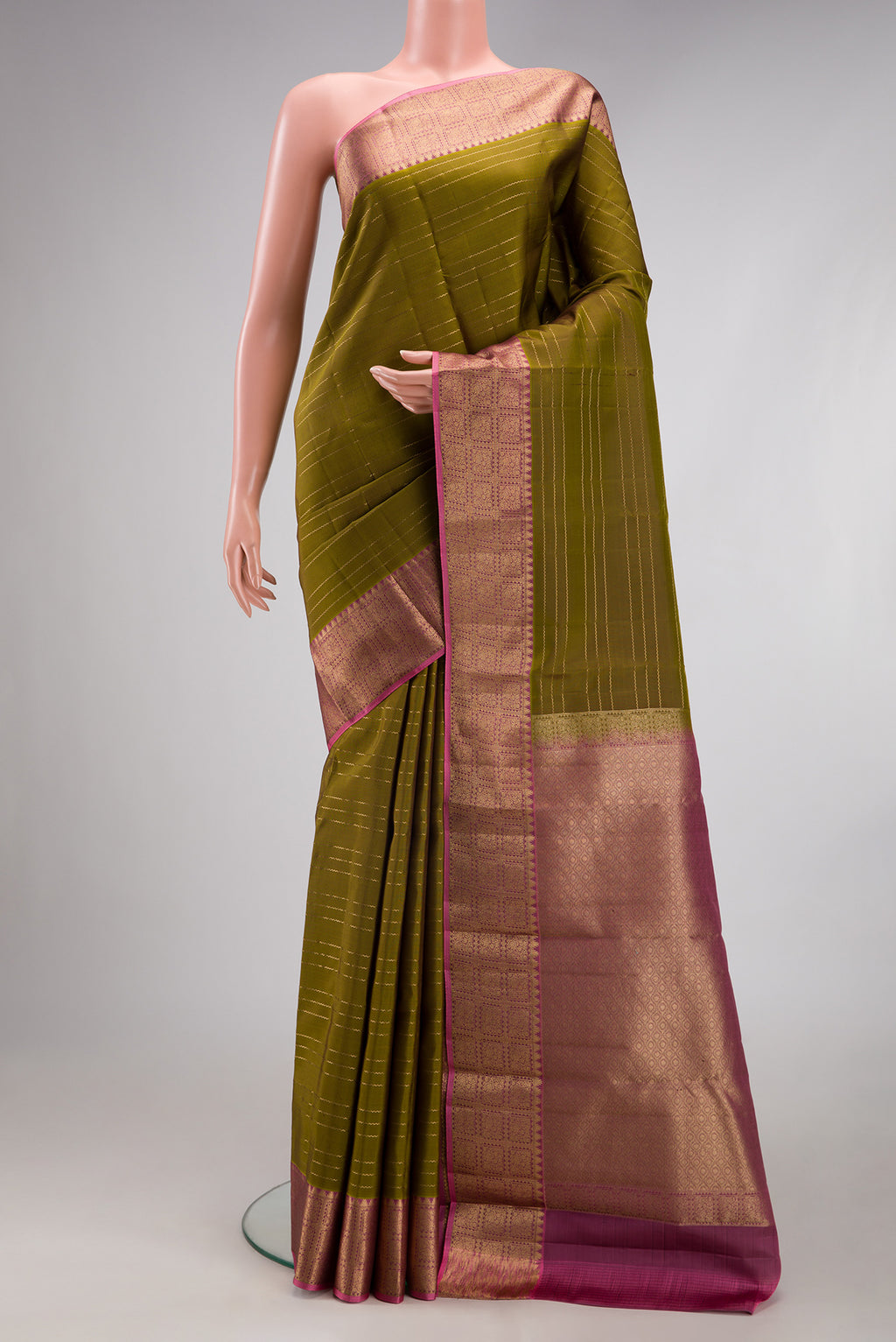 Mehandi Green Kanchipuram Silk Saree with Veldhari on the body and Zari Border.  displayed on a mannequin