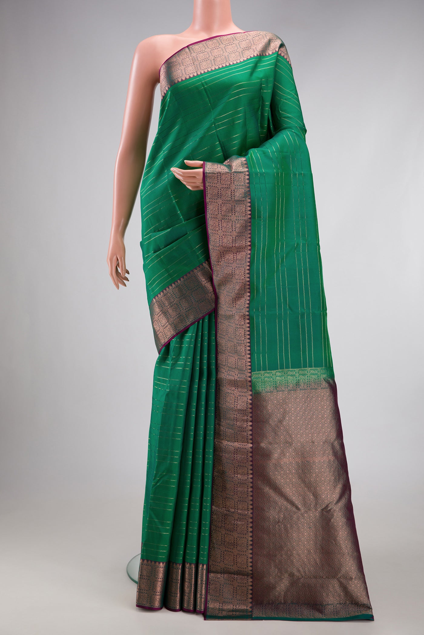 Bottle Green Dual Tone Kanchipuram Silk Saree with Veldhari on the body and Zari Border.  displayed on a mannequin