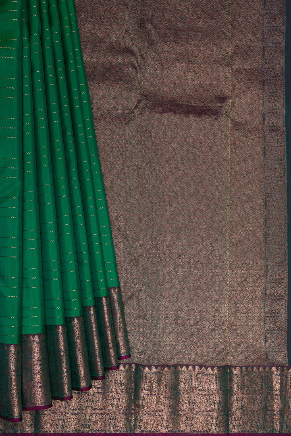 Pleats and pallu of Bottle Green Dual Tone Kanchipuram Silk Saree with Veldhari on the body and Zari Border. 