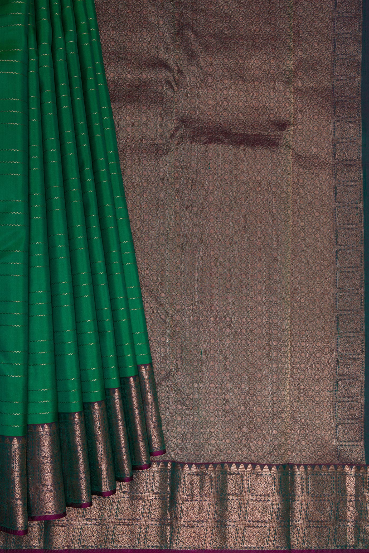 Pleats and pallu of Bottle Green Dual Tone Kanchipuram Silk Saree with Veldhari on the body and Zari Border. 