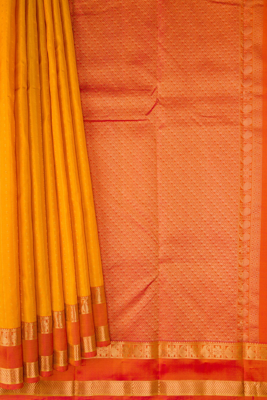 Pleats and pallu of Mustard Kanchipuram Silk Saree with Zari Butta on the body and Zari Border. 