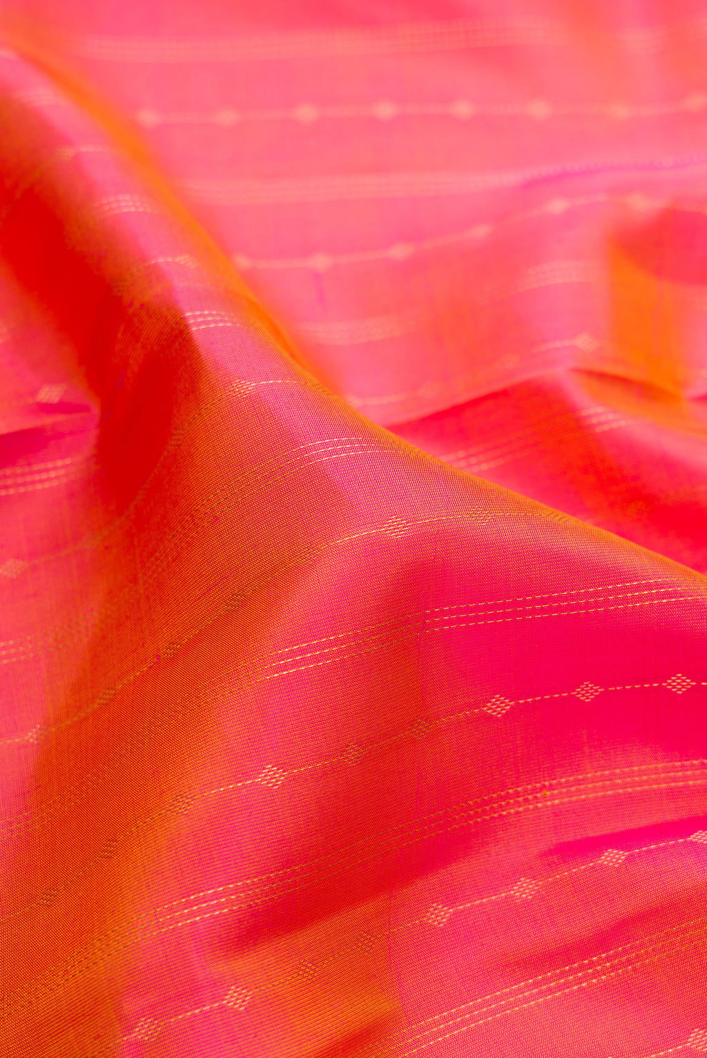 Close up of Pink Dual Tone Kanchipuram Silk Saree with Stripes on the body and Plain Border.  displaying folds