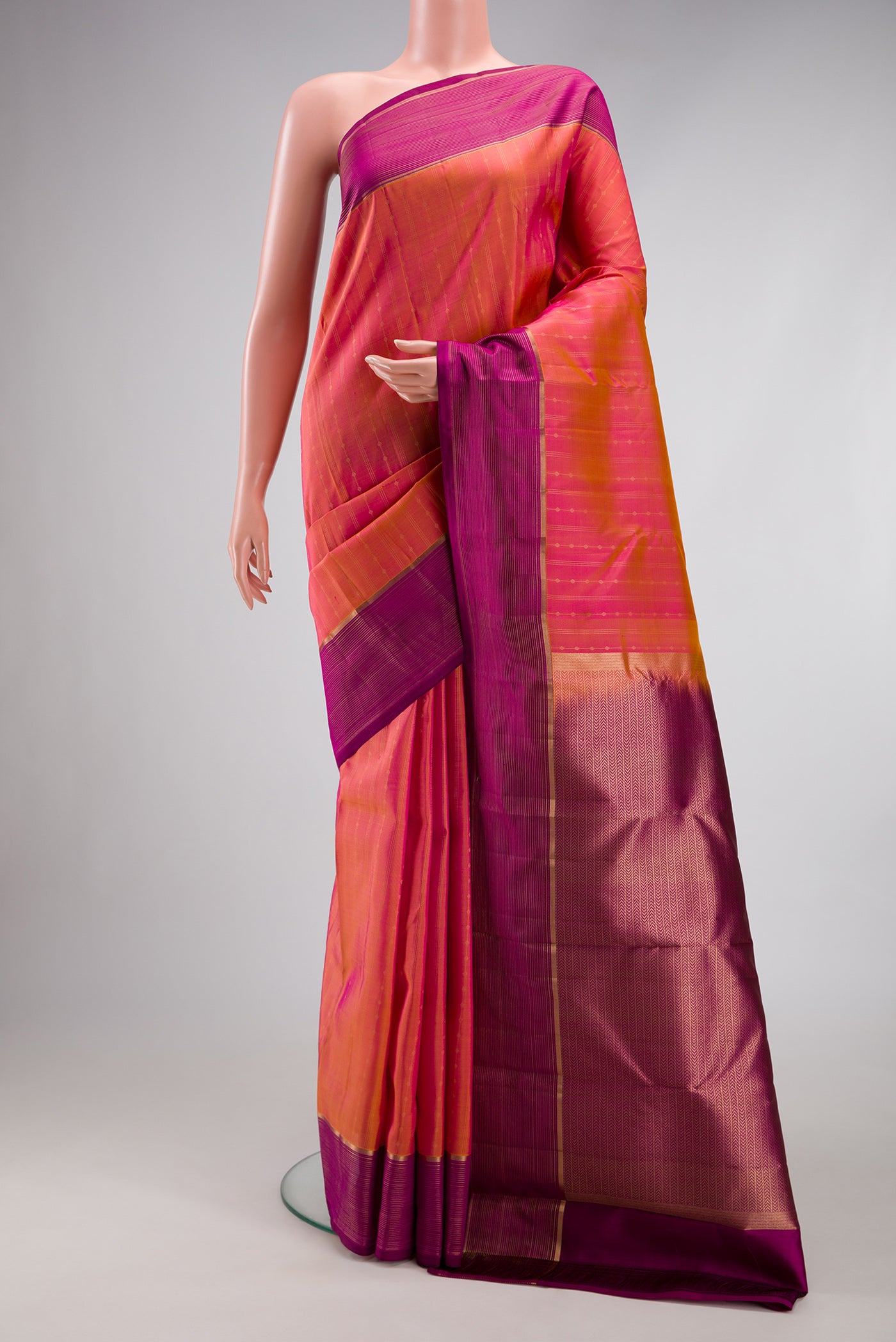 Pink Dual Tone Kanchipuram Silk Saree with Stripes on the body and Plain Border.  displayed on a mannequin