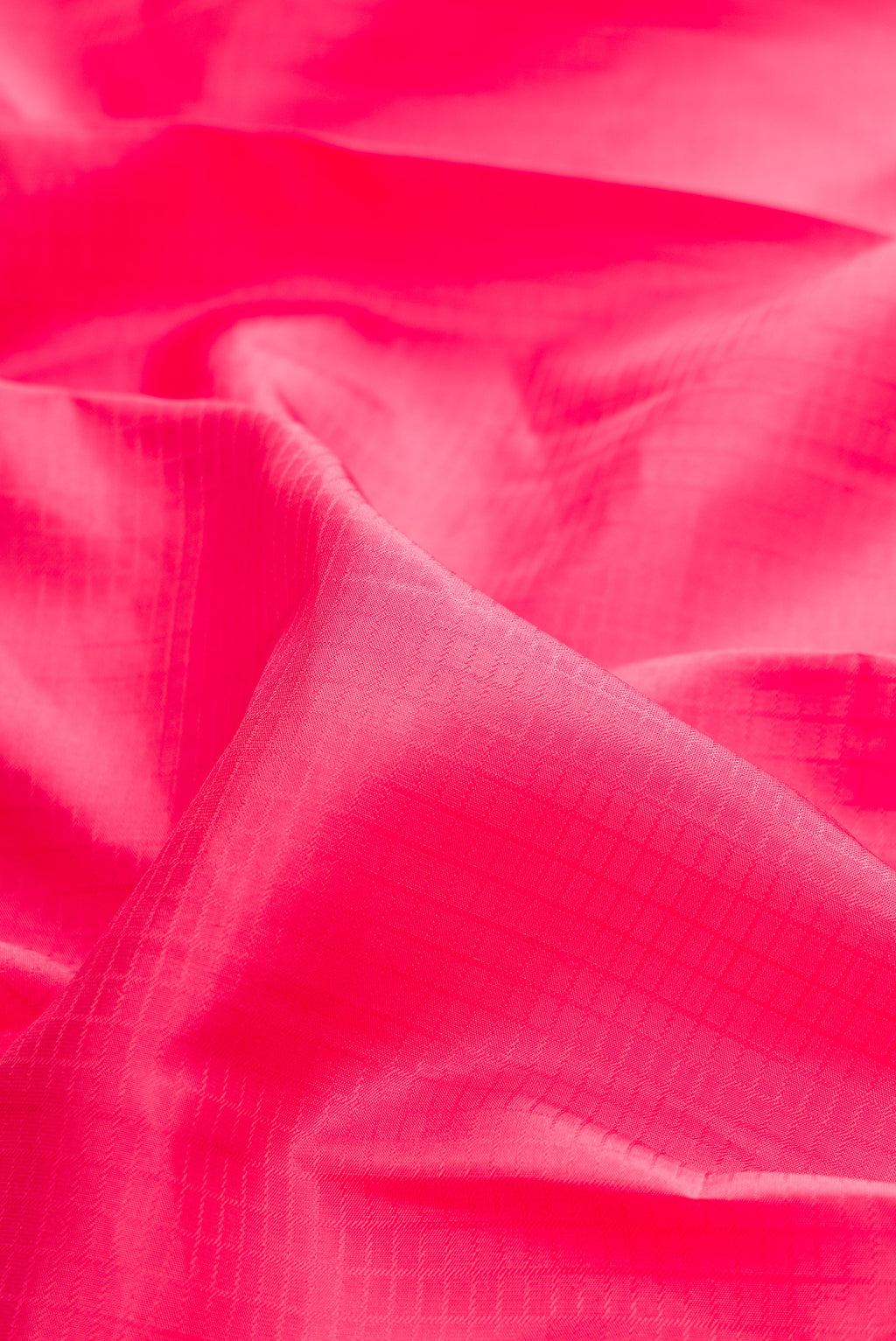 Close up of Pure Silk Pink Kanchipuram Saree with Checked design on the body and Zari Border.  displaying folds