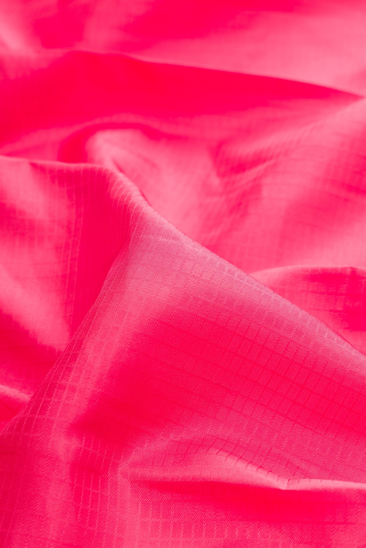 Close up of Pure Silk Pink Kanchipuram Saree with Checked design on the body and Zari Border.  displaying folds