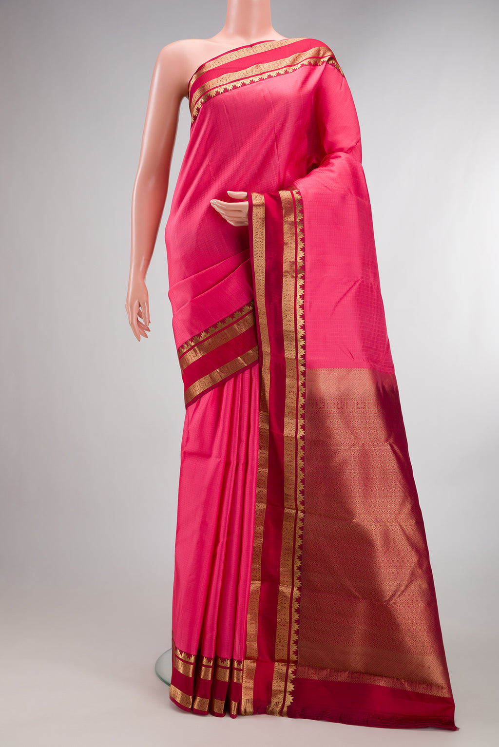 Pure Silk Pink Kanchipuram Saree with Checked design on the body and Zari Border.  displayed on a mannequin
