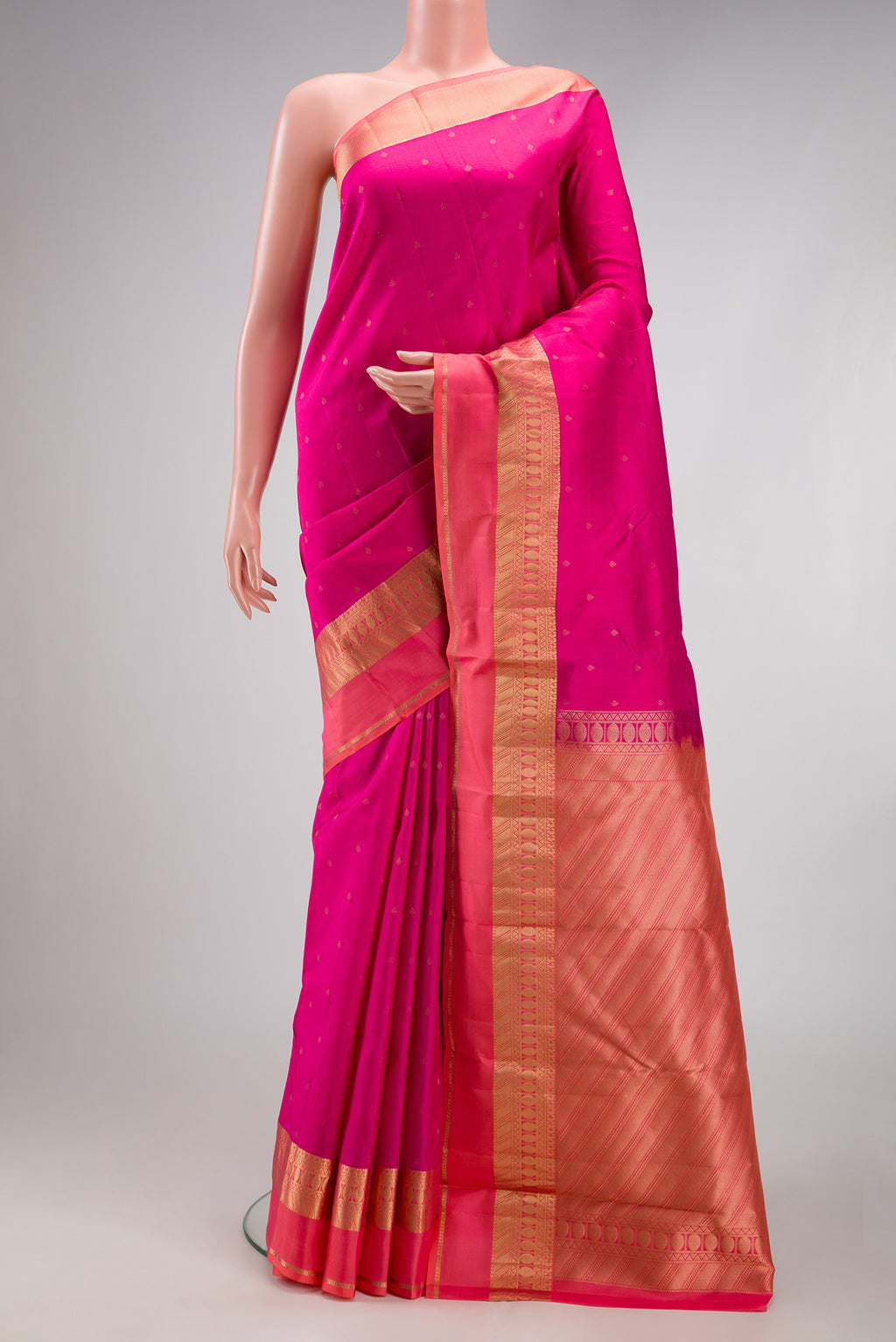 Dark Pink Kanchipuram Silk Saree with Zari Butta on the body and Zari Border.  displayed on a mannequin