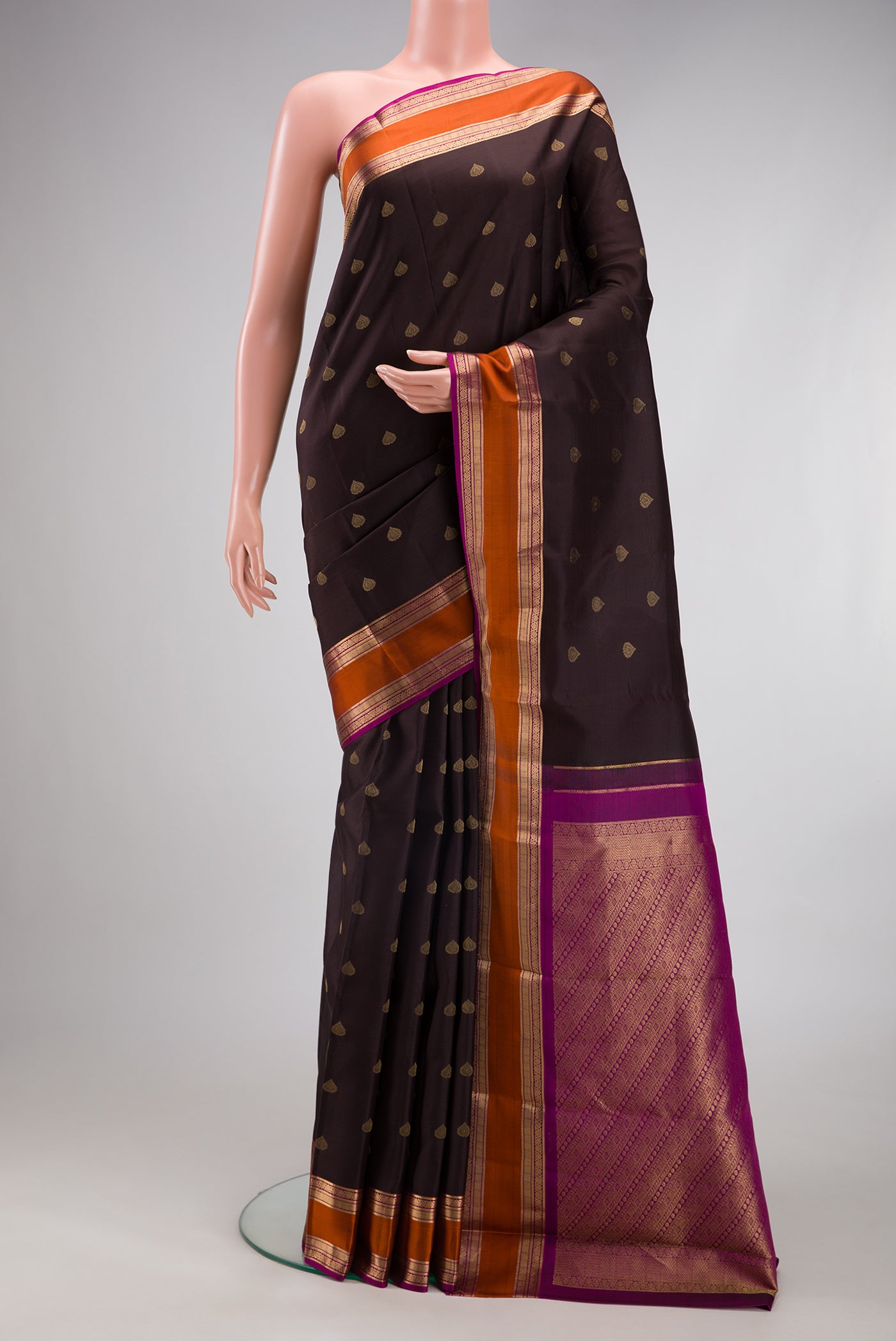 Coffee Brown Kanchipuram Silk Saree with Zari Butta on the body and Zari Border.  displayed on a mannequin