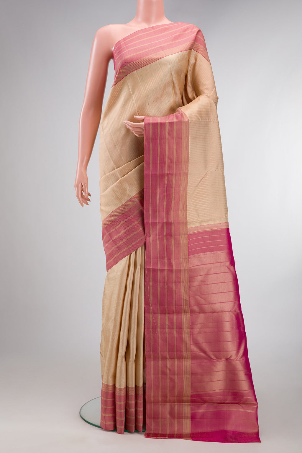Cream Kanchipuram Silk Saree with Stripes on the body and Zari Border.  displayed on a mannequin