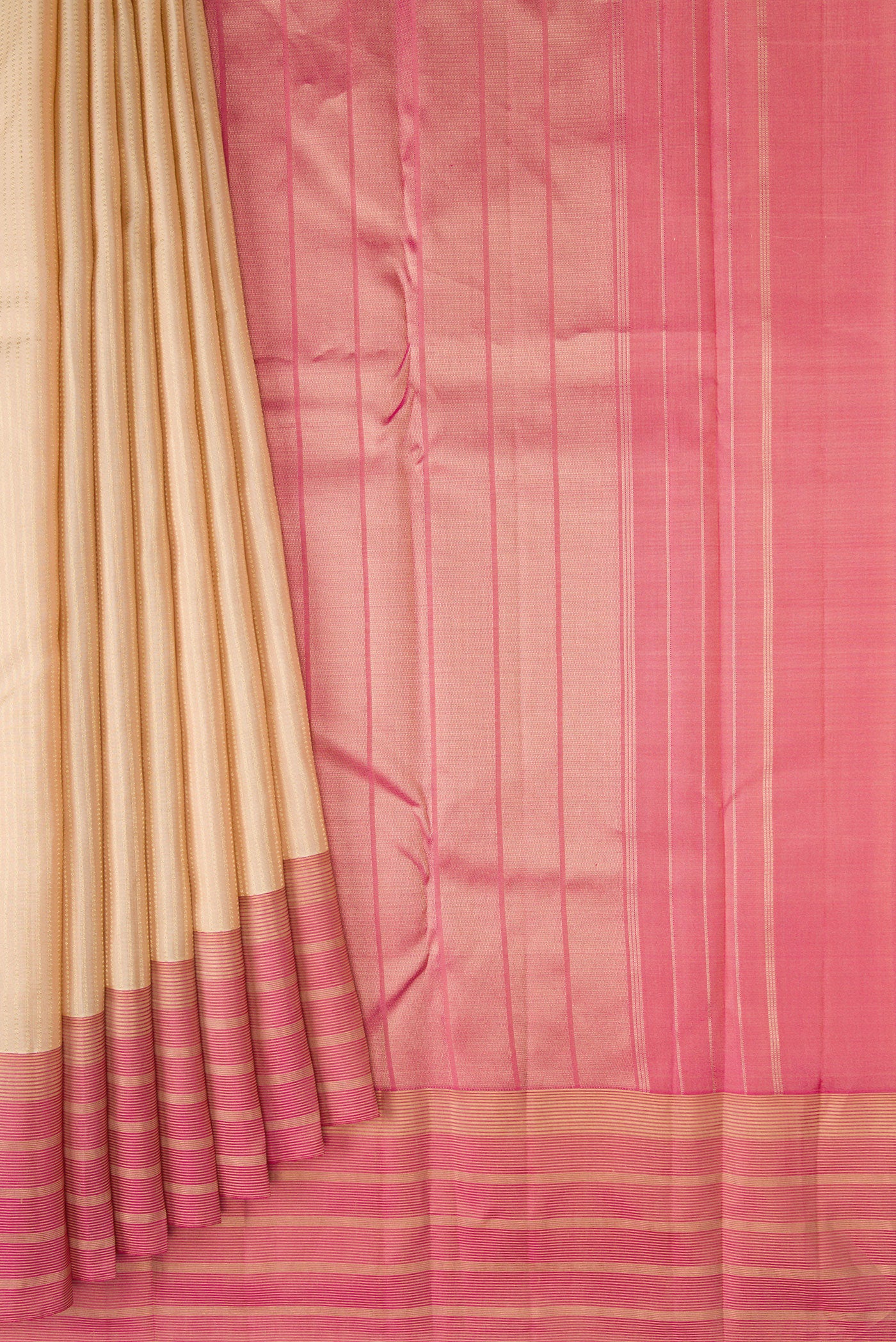 Pleats and pallu of Cream Kanchipuram Silk Saree with Stripes on the body and Zari Border. 