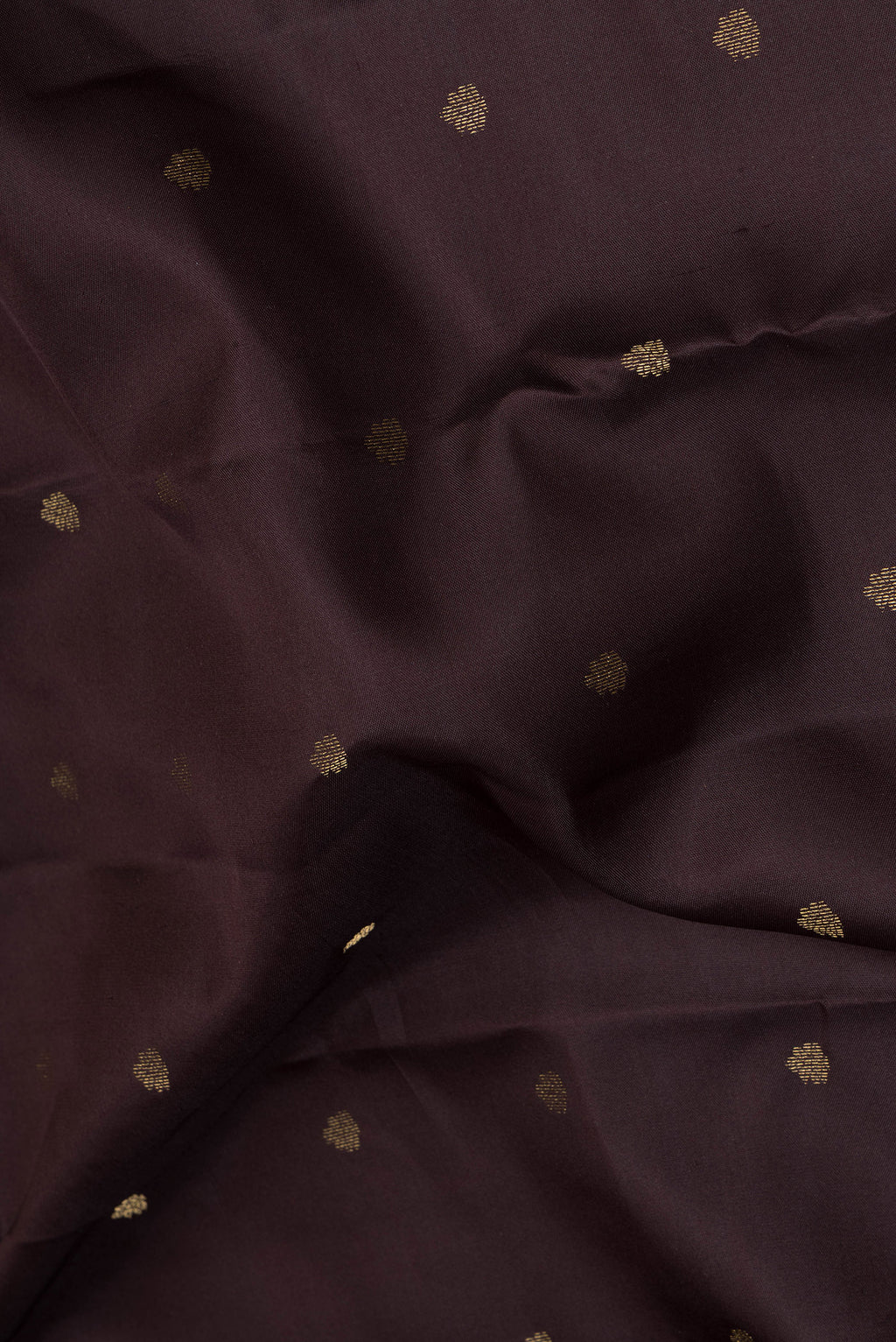 Close up of Coffee Brown Kanchipuram Silk Saree with Zari Butta on the body and Zari Border.  displaying folds