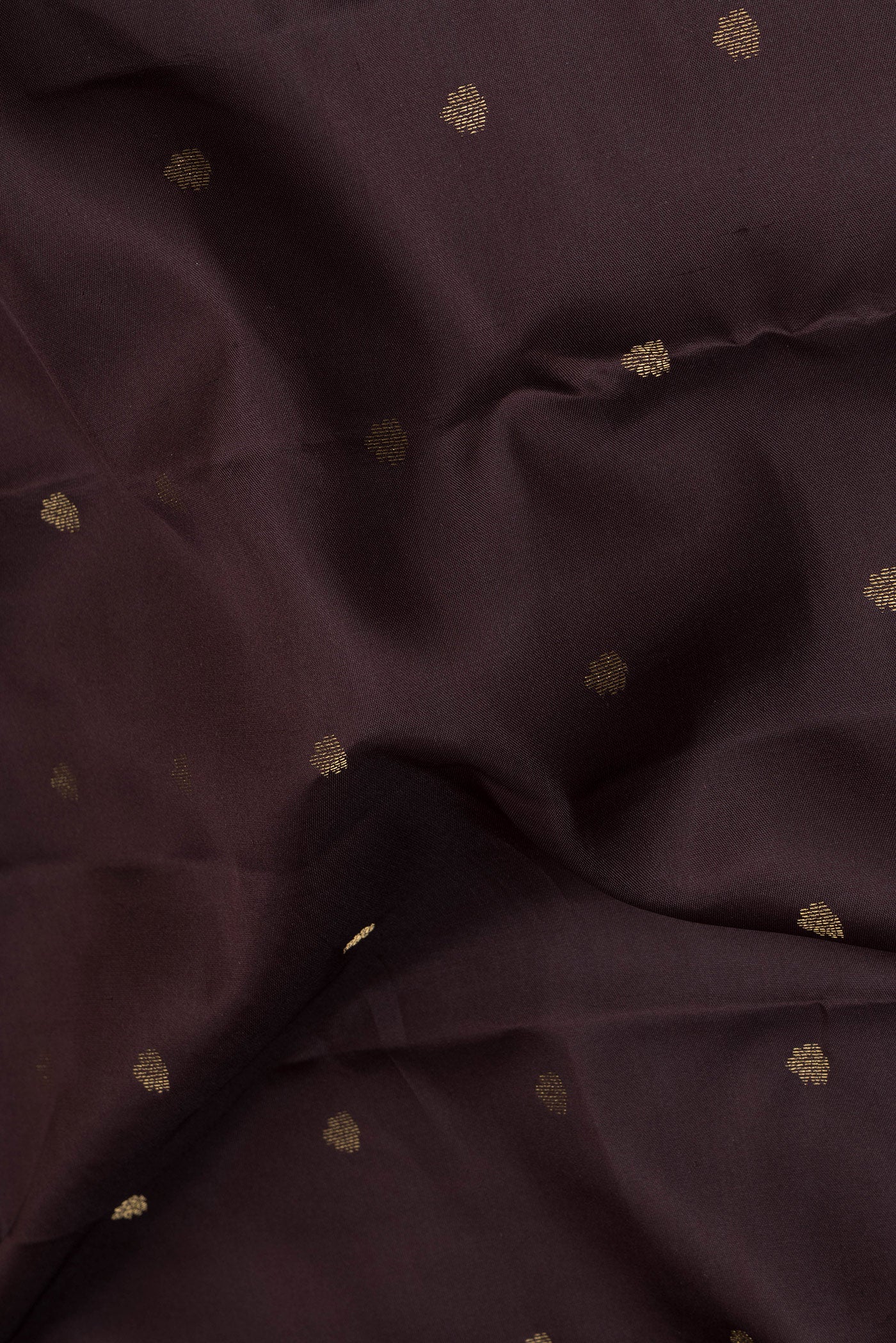 Close up of Coffee Brown Kanchipuram Silk Saree with Zari Butta on the body and Zari Border.  displaying folds