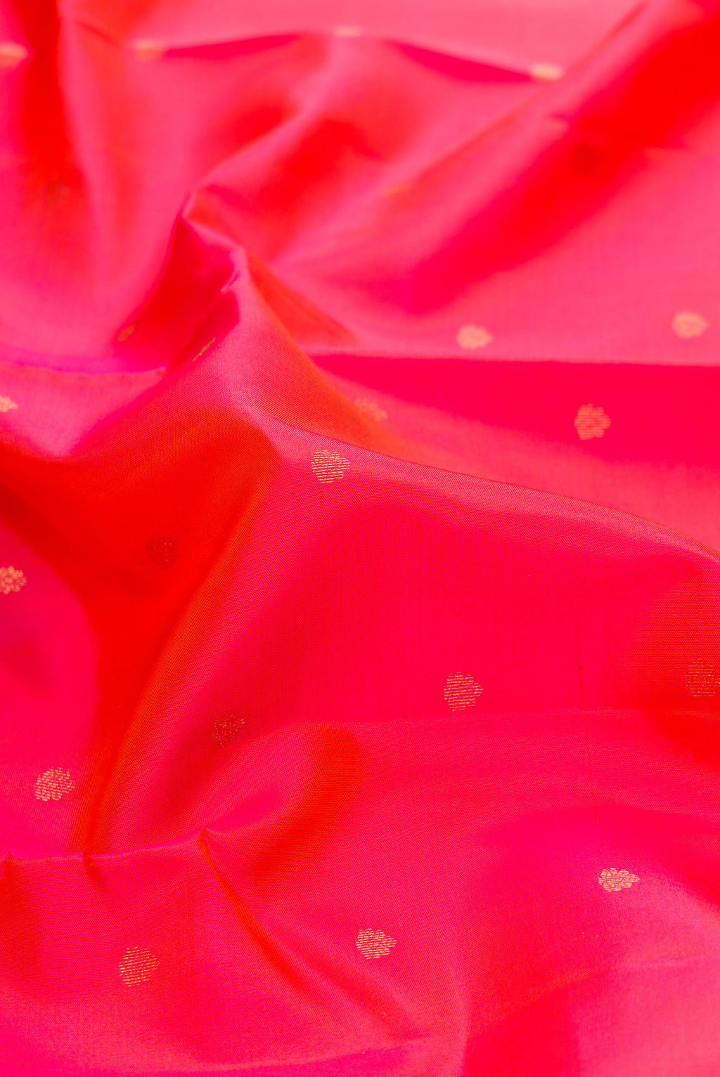 Close up of Pink Dual Tone Kanchipuram Silk Saree with Zari Butta on the body and Zari Border.  displaying folds