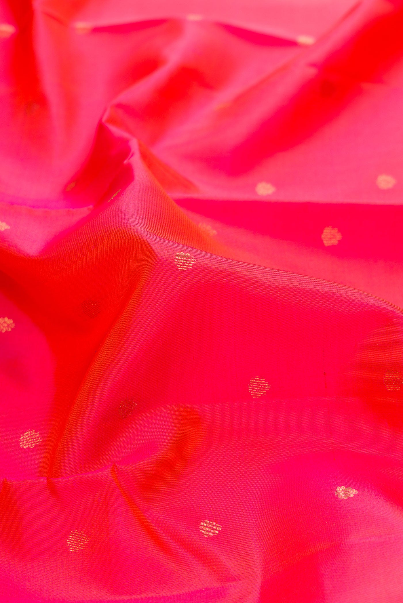 Close up of Pink Dual Tone Kanchipuram Silk Saree with Zari Butta on the body and Zari Border.  displaying folds