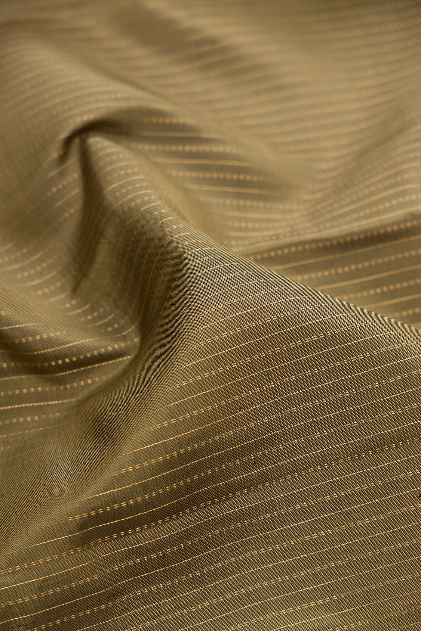 Close up of Mehandi Green Kanjivaram Silk Saree with Stripes on the body and Zari Border.  displaying folds