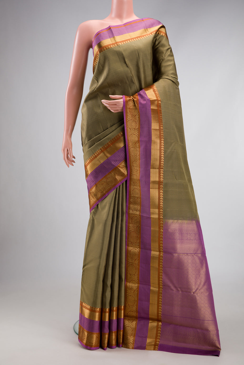 Mehandi Green Kanjivaram Silk Saree with Stripes on the body and Zari Border.  displayed on a mannequin