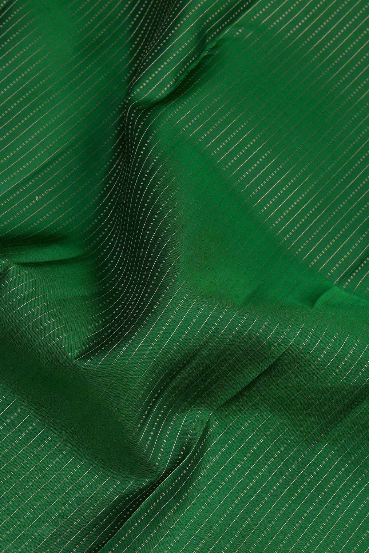 Close up of Bottle Green Kanjivaram Silk Saree with Stripes on the body and Zari Border.  displaying folds