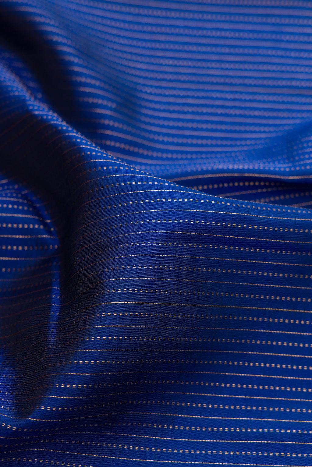 Close up of Navy Blue Dual Tone Kanjivaram Silk Saree with Stripes on the body and Fancy Border.  displaying folds