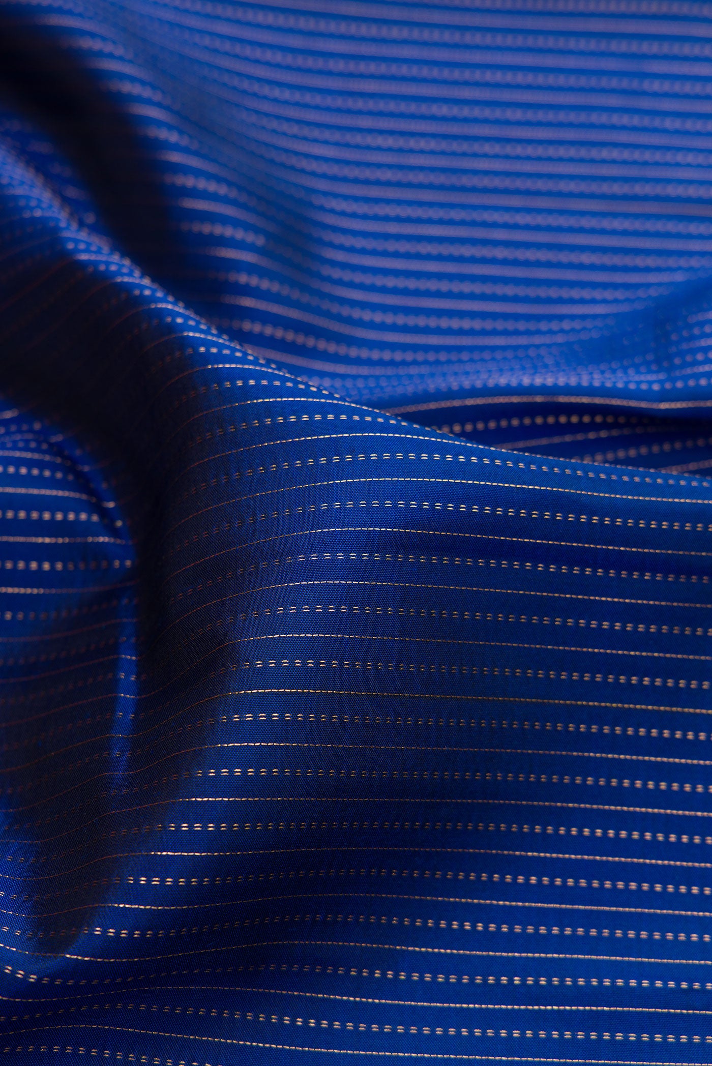 Close up of Navy Blue Dual Tone Kanjivaram Silk Saree with Stripes on the body and Fancy Border.  displaying folds