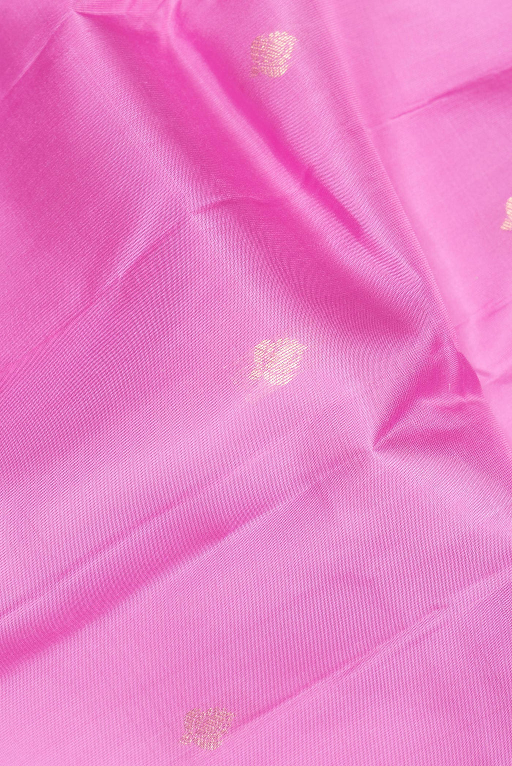 Close up of Pure Silk Rose pink Kanchipuram Saree with Zari Butta on the body and Zari Border.  displaying folds