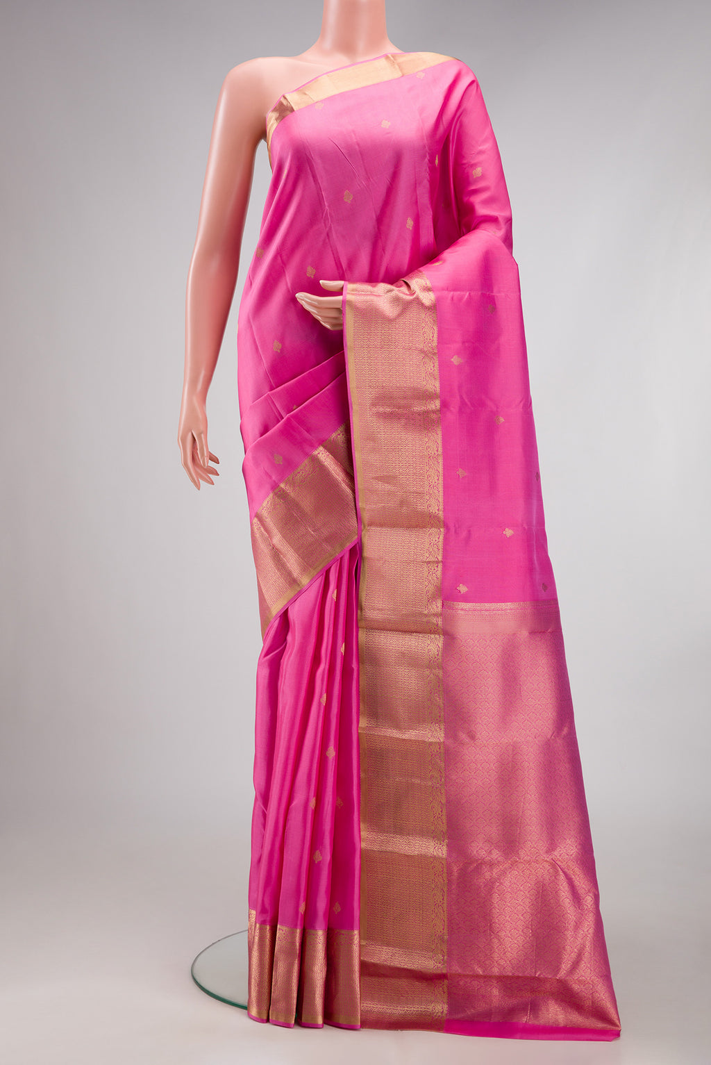 Pink Kanchipuram Silk Saree with Zari Butta on the body and Zari Border.  displayed on a mannequin