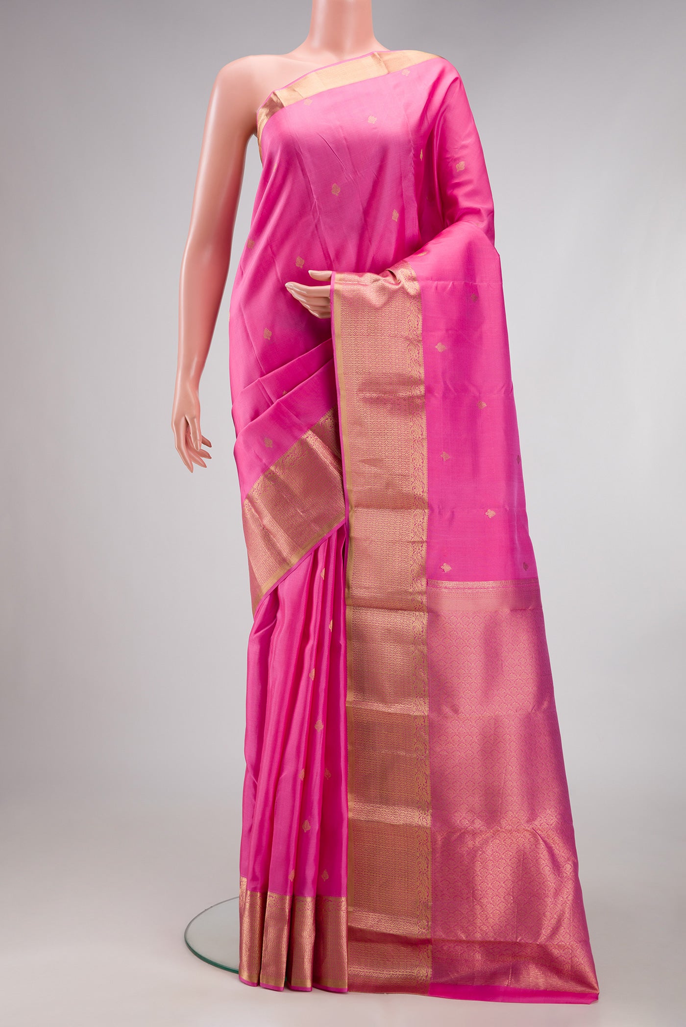 Pink Kanchipuram Silk Saree with Zari Butta on the body and Zari Border.  displayed on a mannequin