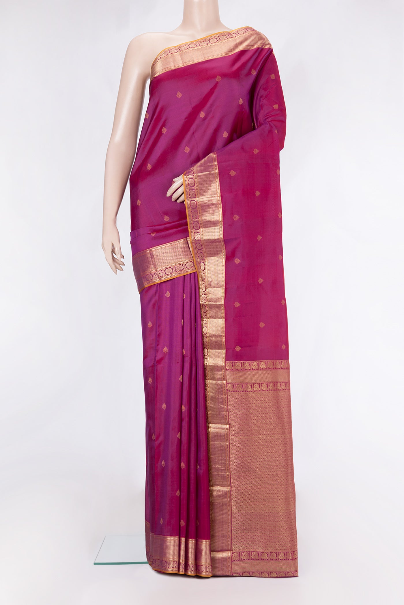 Magenta Kanchipuram Silk Saree with Zari Butta on the body and Zari Border.  displayed on a mannequin