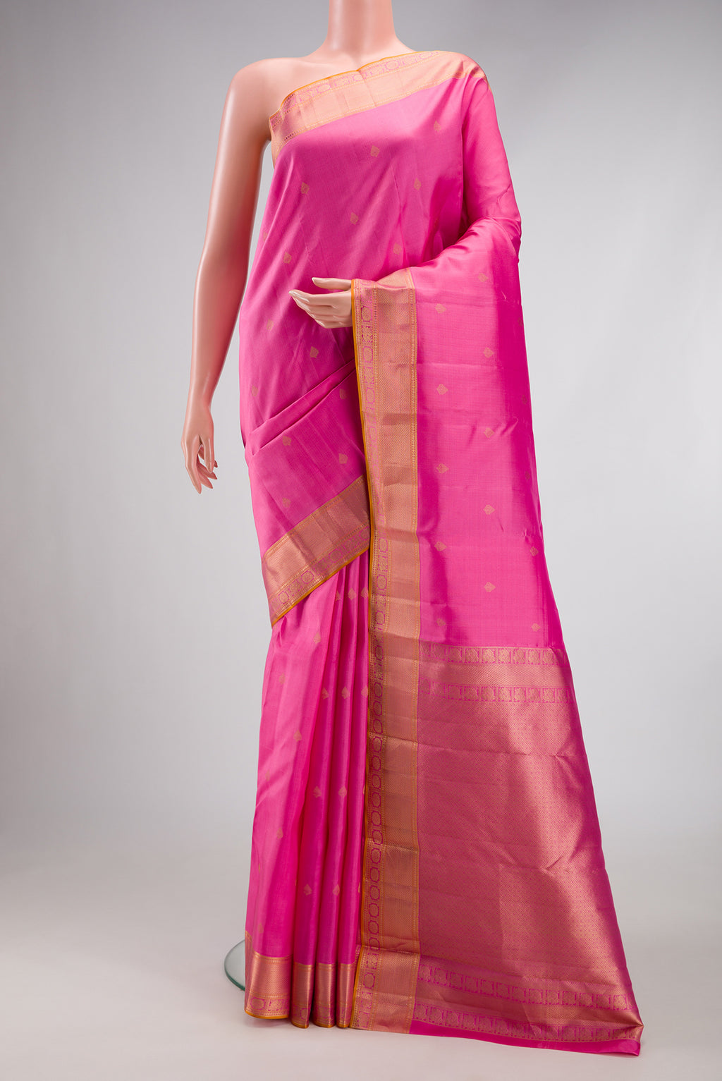 Rose pink Kanchipuram Silk Saree with Zari Butta on the body and Zari Border.  displayed on a mannequin