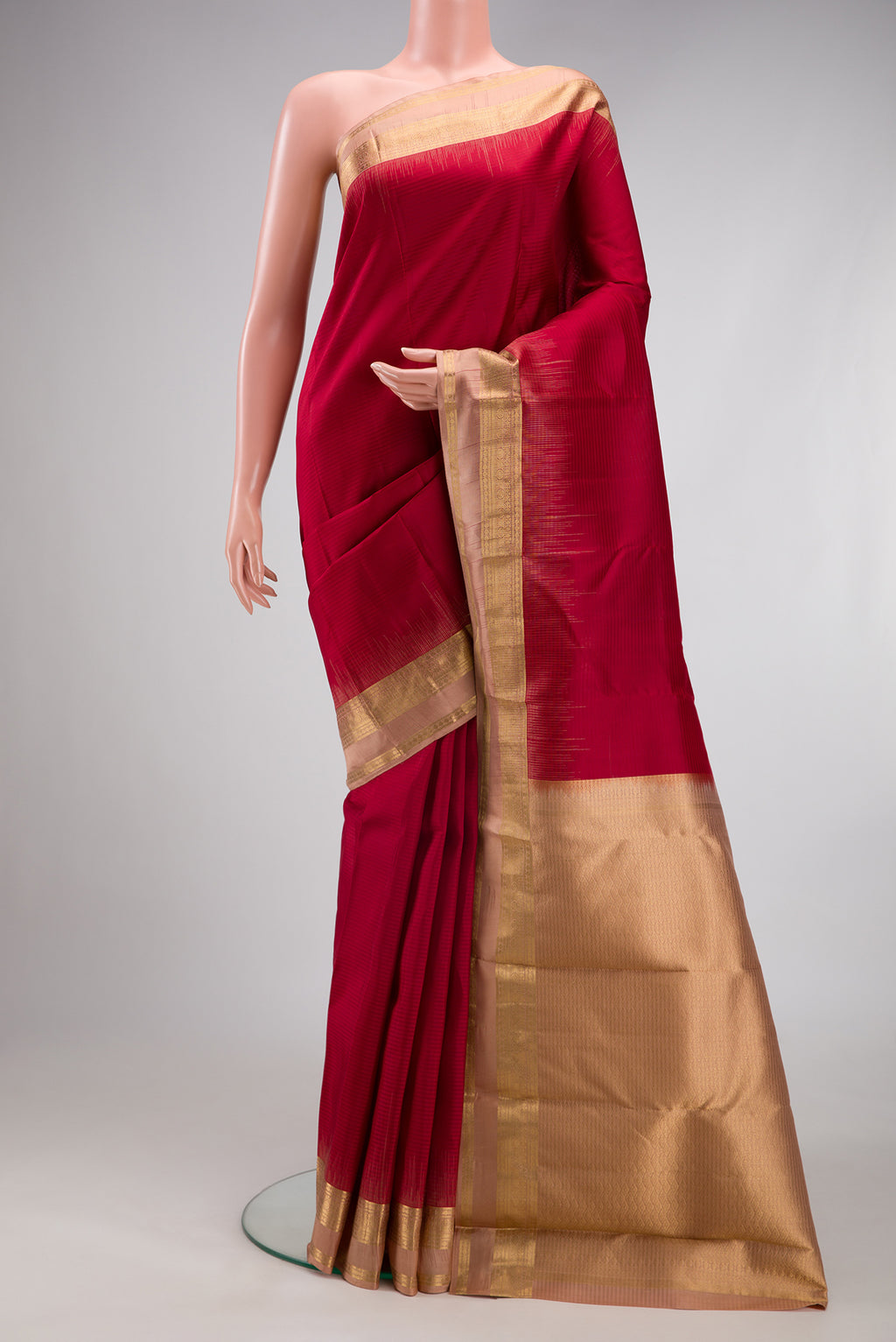 Maroon Kanchipuram Silk Saree with Stripes on the body and Zari Border.  displayed on a mannequin