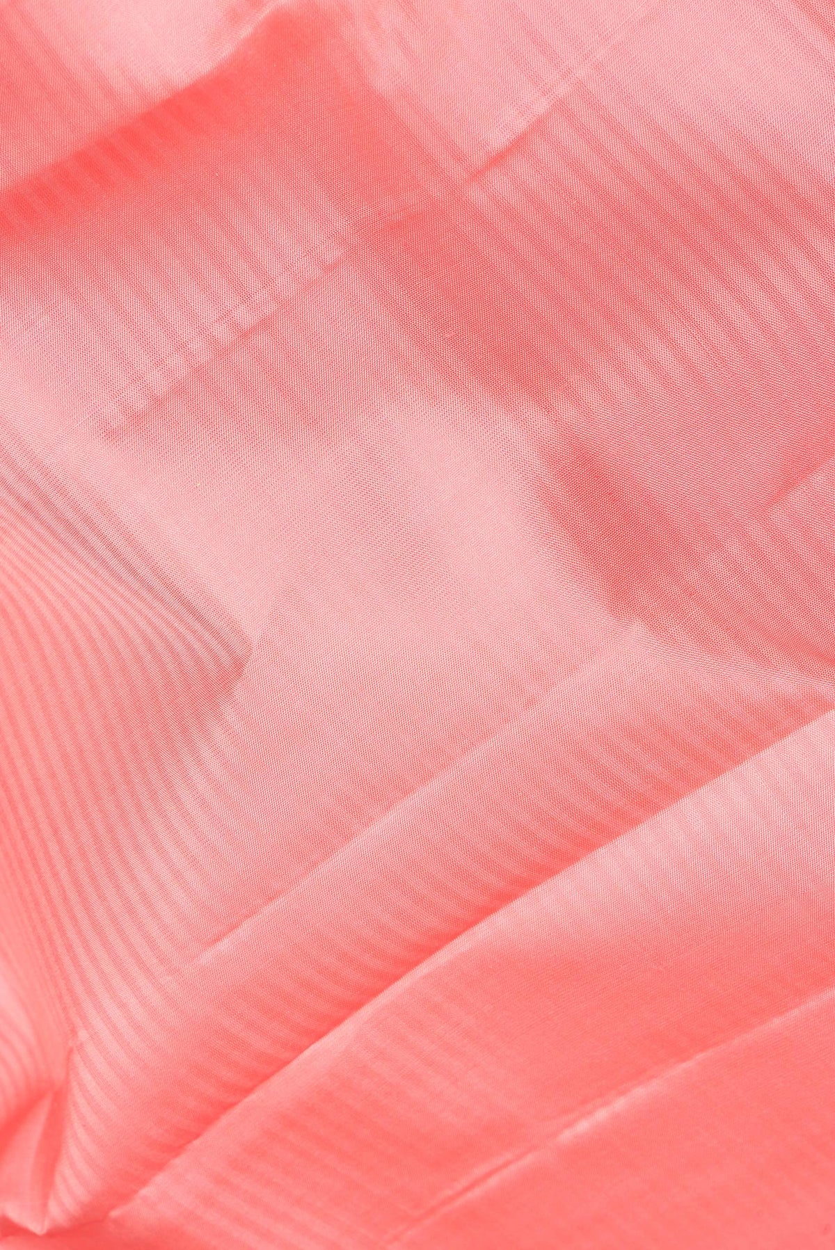 Close up of Pure Silk Peach Kanchipuram Saree with Stripes on the body and Zari Border.  displaying folds