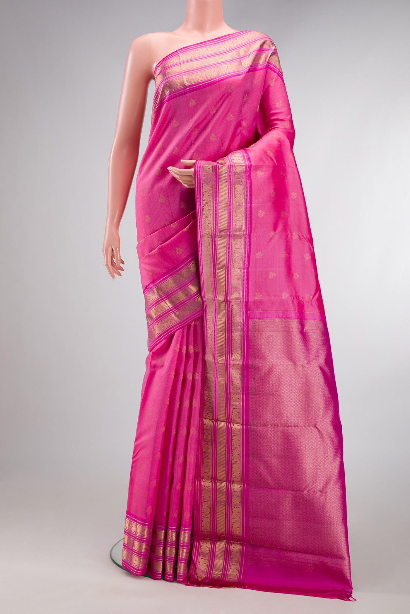 Pink Kanchipuram Silk Saree with Zari Butta on the body and Zari Border.  displayed on a mannequin