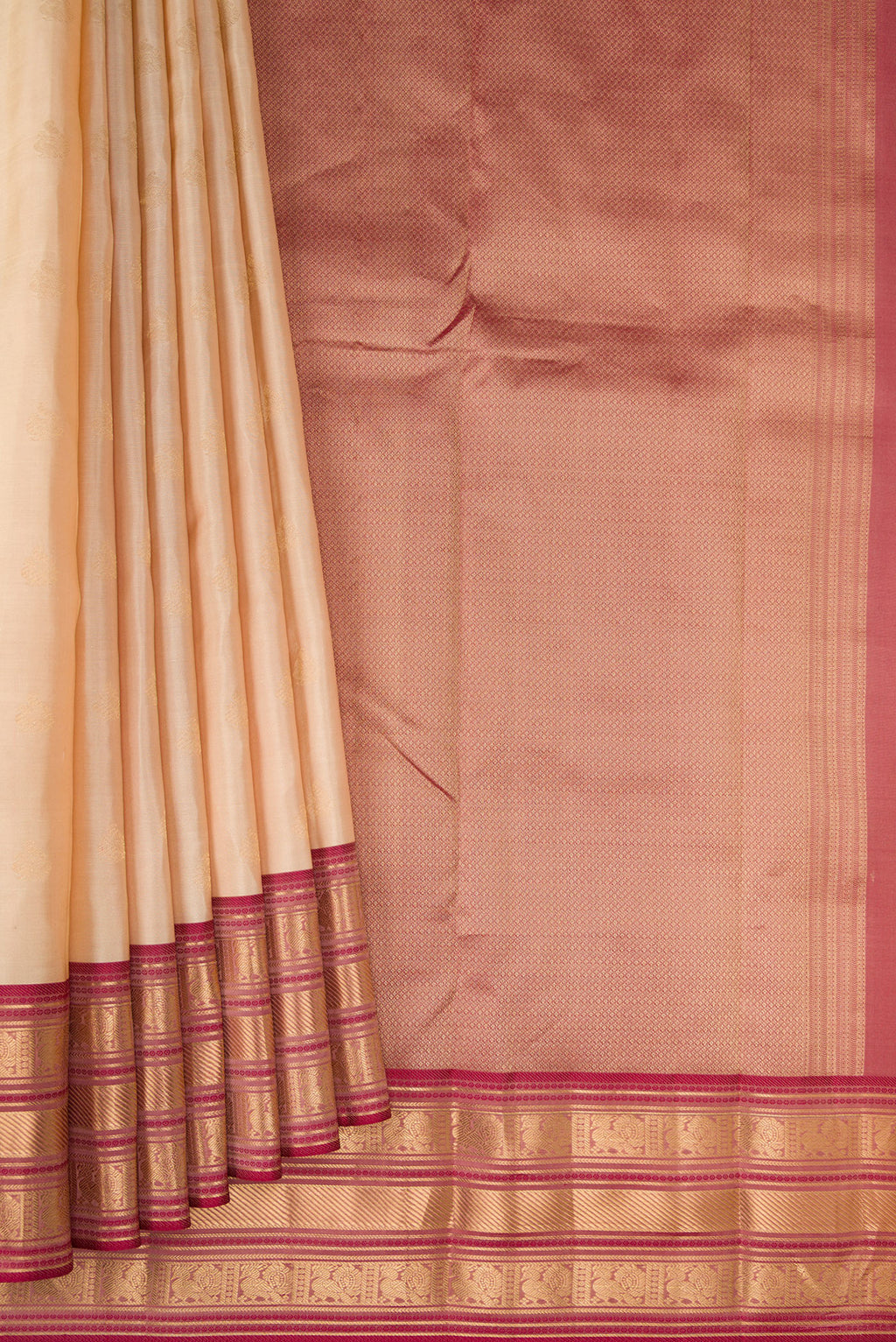 Pleats and pallu of Beige Kanchipuram Silk Saree with Zari Butta on the body and Zari Border. 