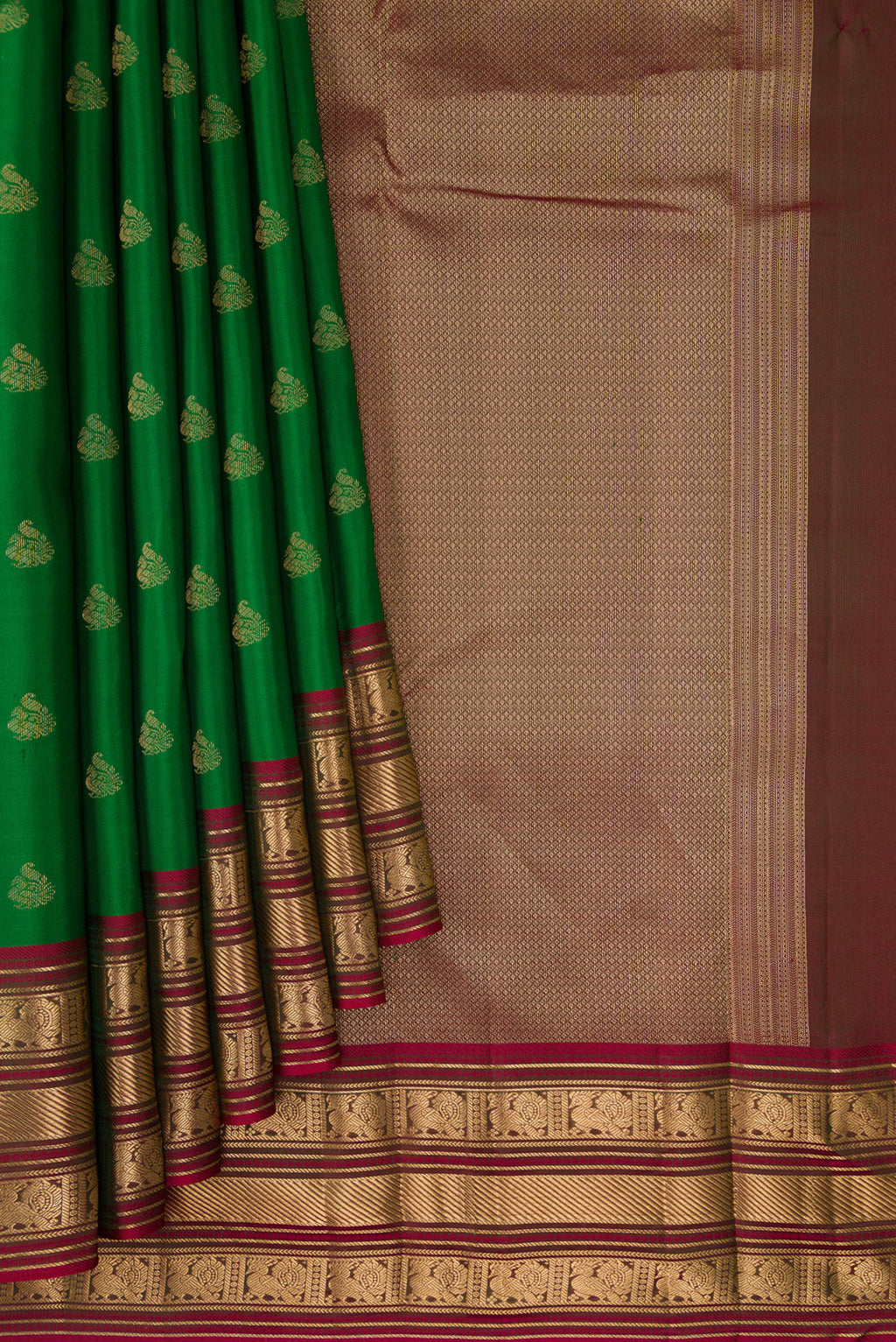 Pleats and pallu of Green Kanchipuram Silk Saree with Zari Butta on the body and Zari Border. 