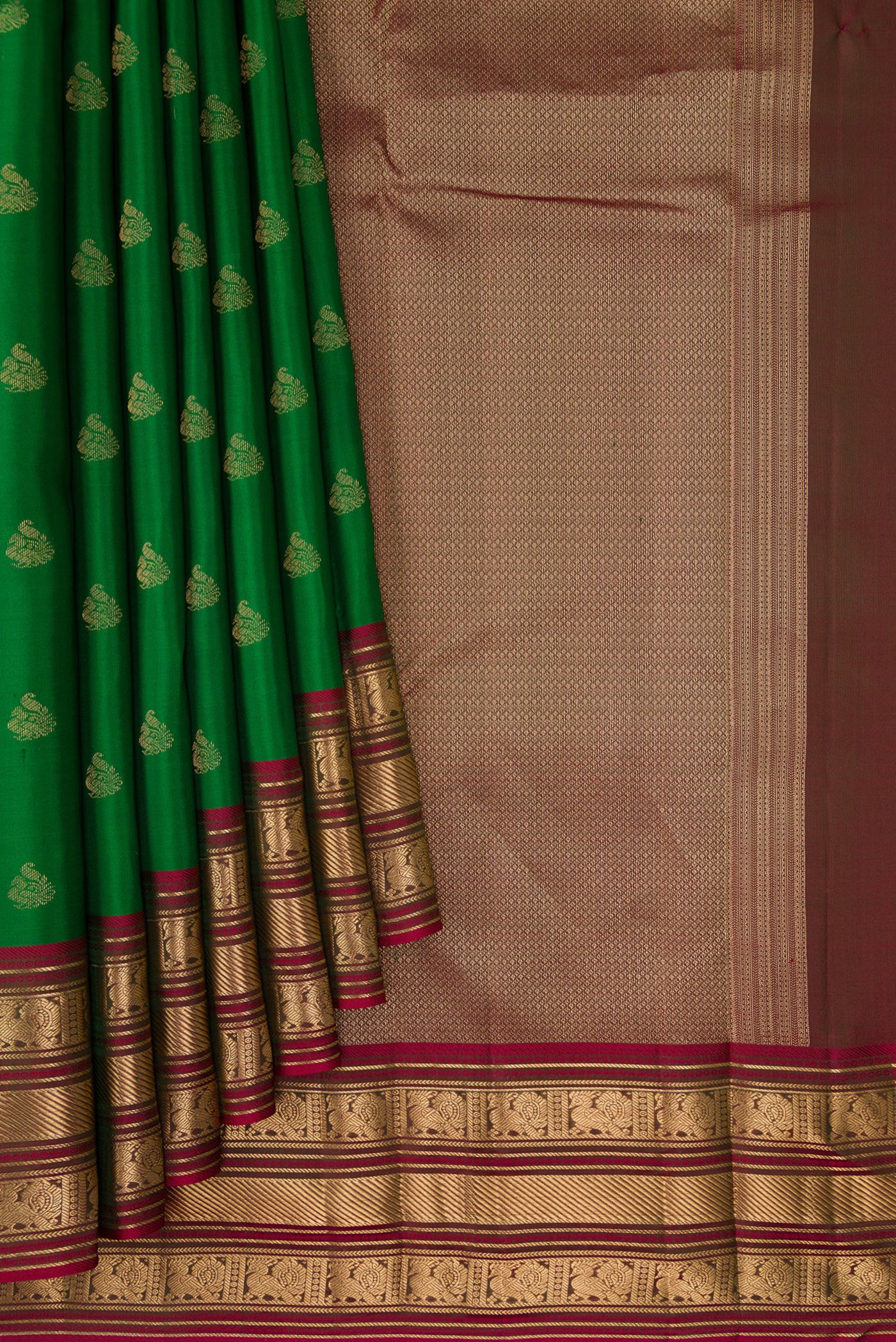 Pleats and pallu of Green Kanchipuram Silk Saree with Zari Butta on the body and Zari Border. 