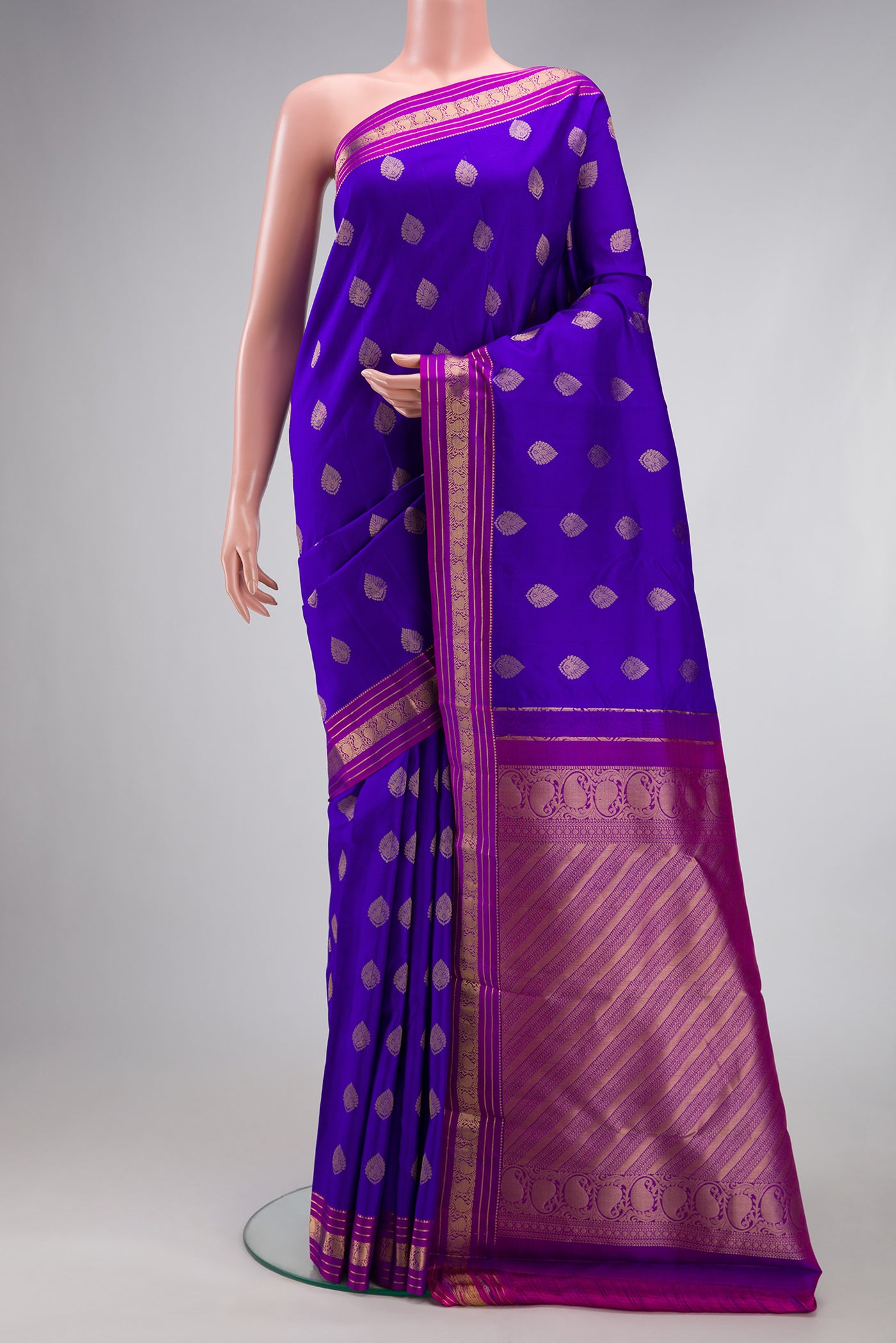 Royal Blue Kanchipuram Silk Saree with Zari Butta on the body and Zari Border.  displayed on a mannequin