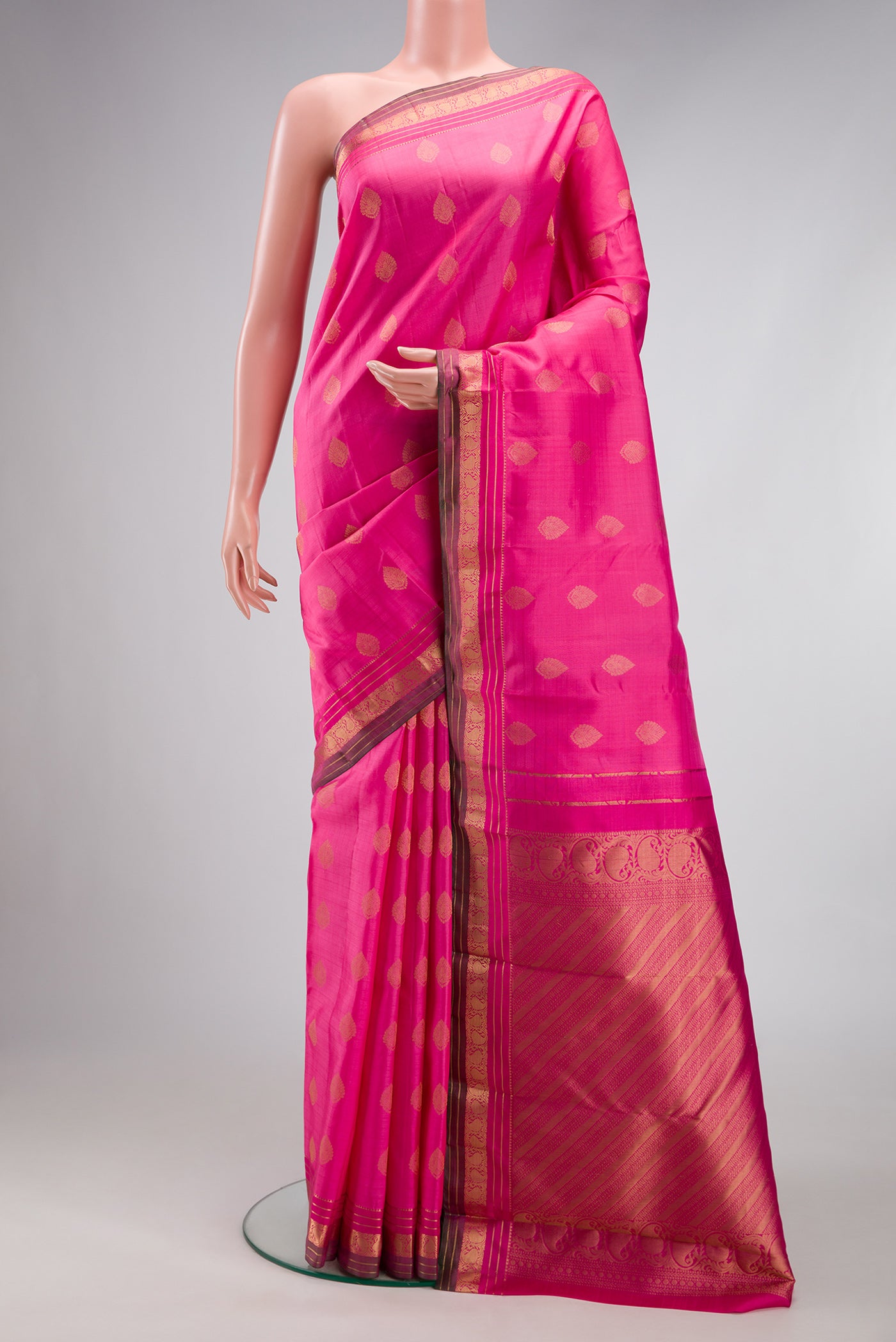 Pink Kanchipuram Silk Saree with Zari Butta on the body and Zari Border.  displayed on a mannequin