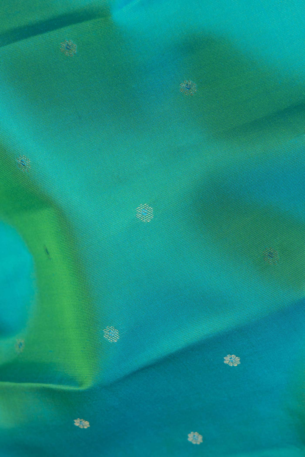 Close up of Pure Silk Sea Green Kanchipuram Saree with Zari Butta on the body and Zari Border.  displaying folds