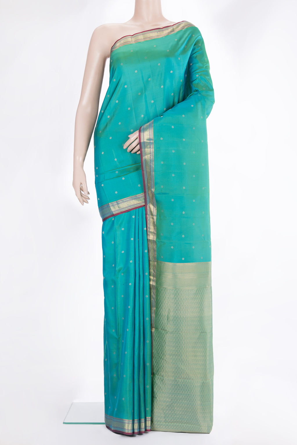 Pure Silk Sea Green Kanchipuram Saree with Zari Butta on the body and Zari Border.  displayed on a mannequin