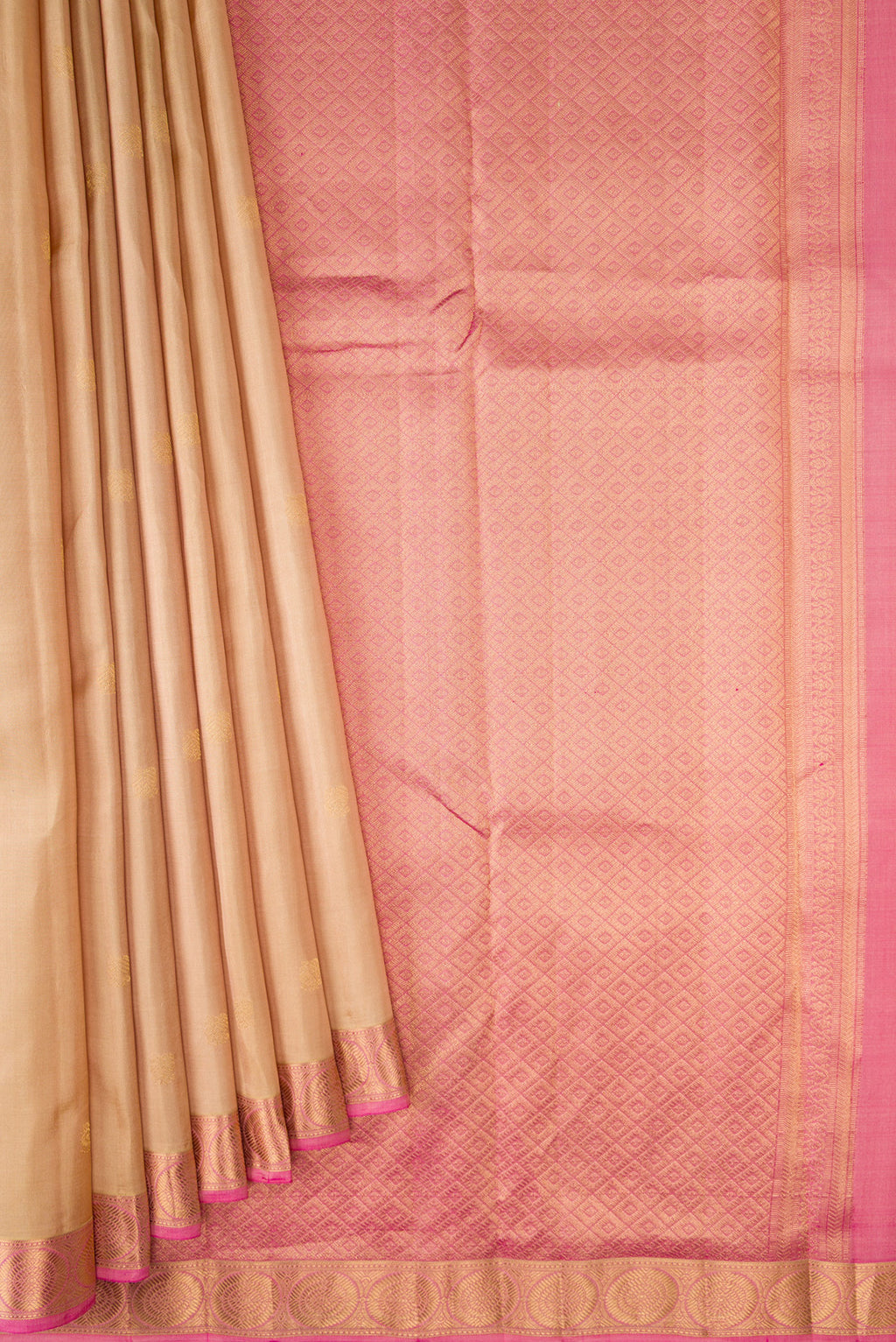 Pleats and pallu of Beige Kanchipuram Silk Saree with Zari Butta on the body and Zari Border. 