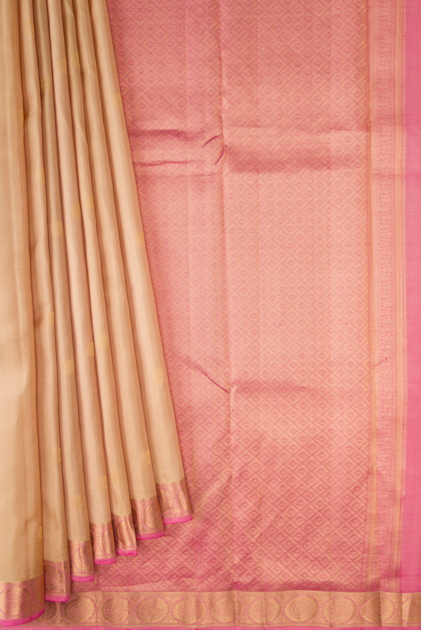 Pleats and pallu of Beige Kanchipuram Silk Saree with Zari Butta on the body and Zari Border. 