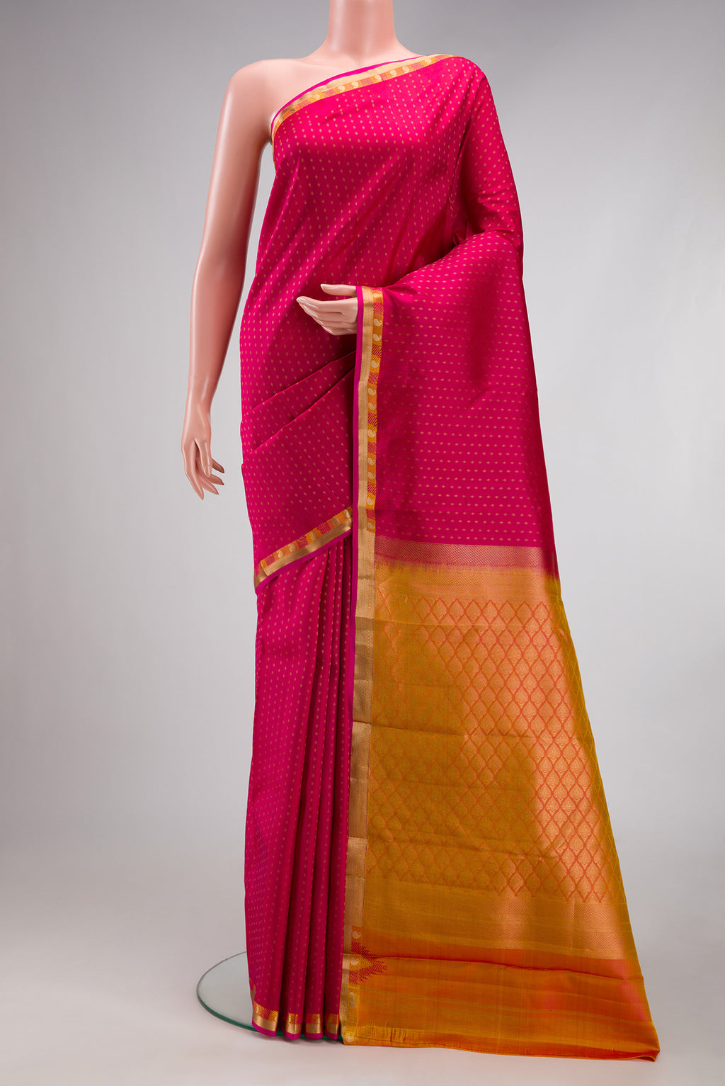 Pink Kanchipuram Silk Saree with Zari Butta on the body and Zari Border.  displayed on a mannequin