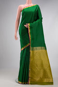 Green Kanchipuram Silk Saree with Zari Butta on the body and Zari Border.  displayed on a mannequin