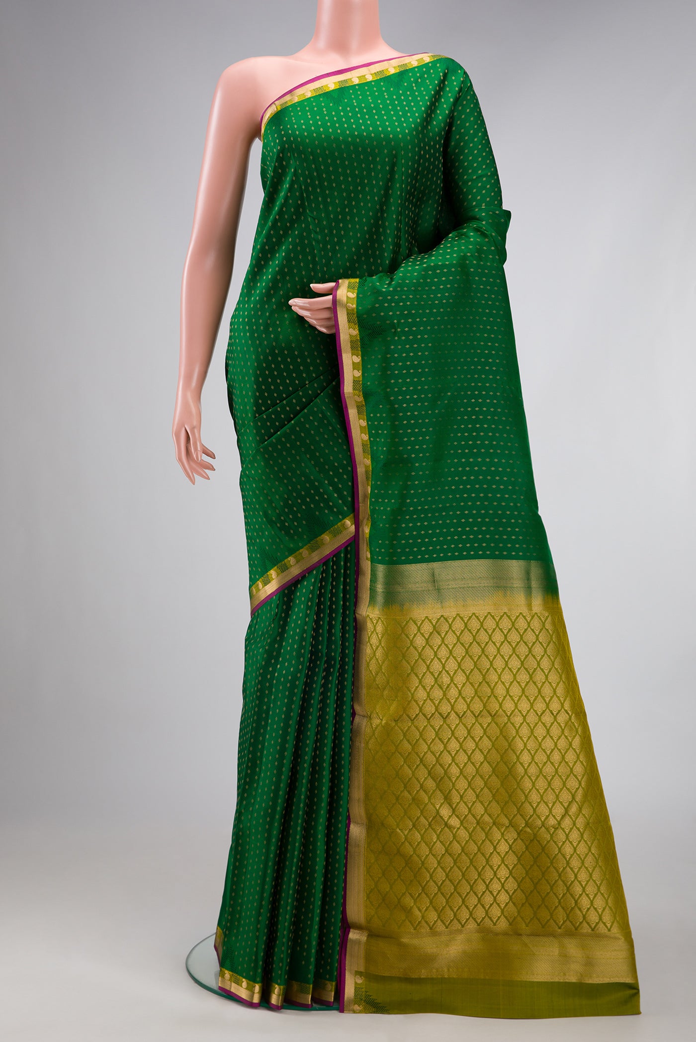 Green Kanchipuram Silk Saree with Zari Butta on the body and Zari Border.  displayed on a mannequin