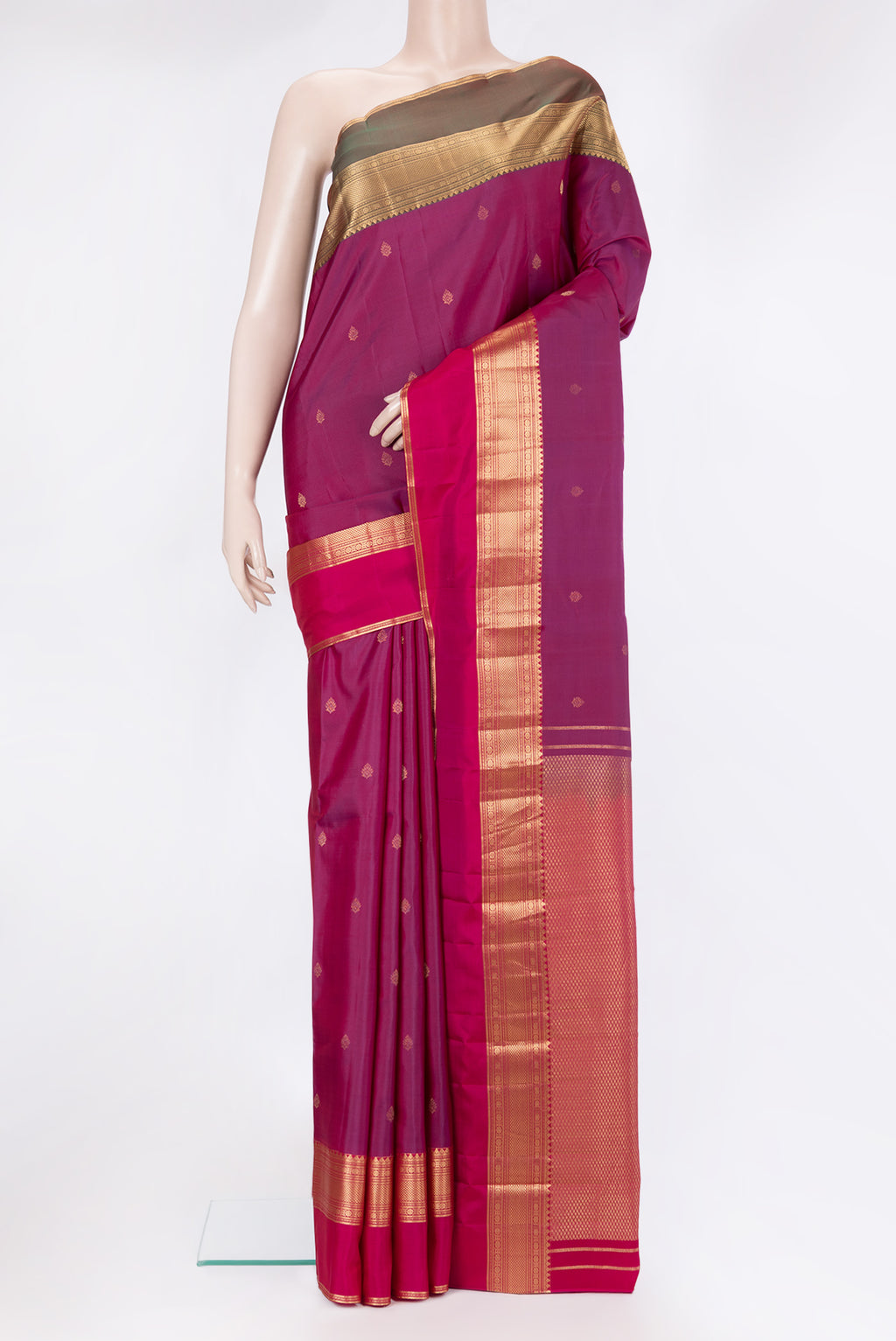 Magenta Kanchipuram Silk Saree with Zari Butta on the body and Ganga Jamuna Border.  displayed on a mannequin
