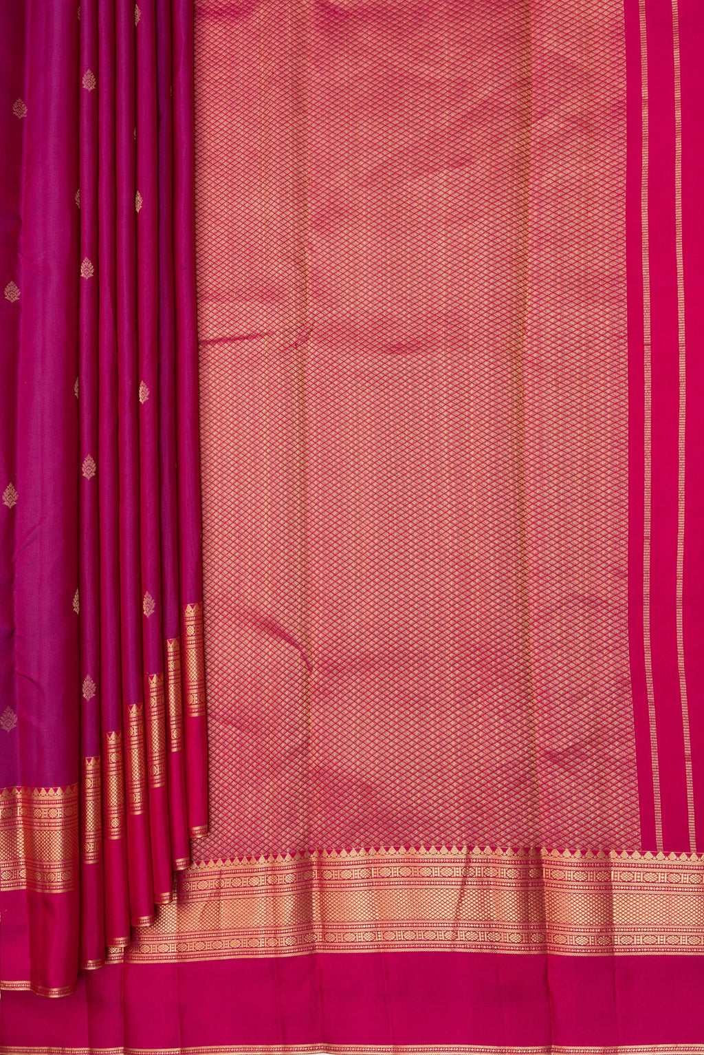 Pleats and pallu of Magenta Kanchipuram Silk Saree with Zari Butta on the body and Ganga Jamuna Border. 