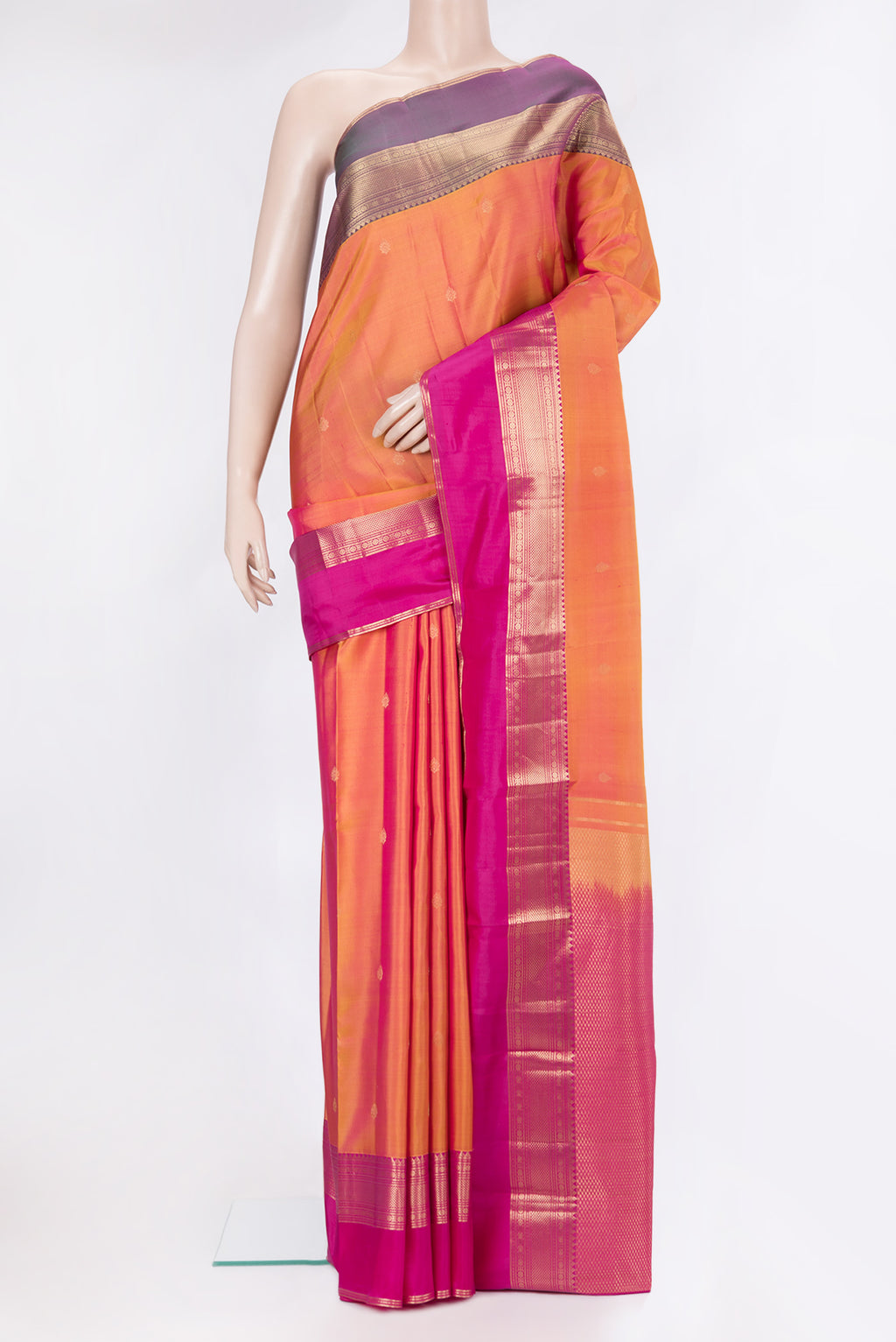 Pinkish Yellow Dual Tone Kanchipuram Silk Saree with Zari Butta on the body and Ganga Jamuna Border.  displayed on a mannequin