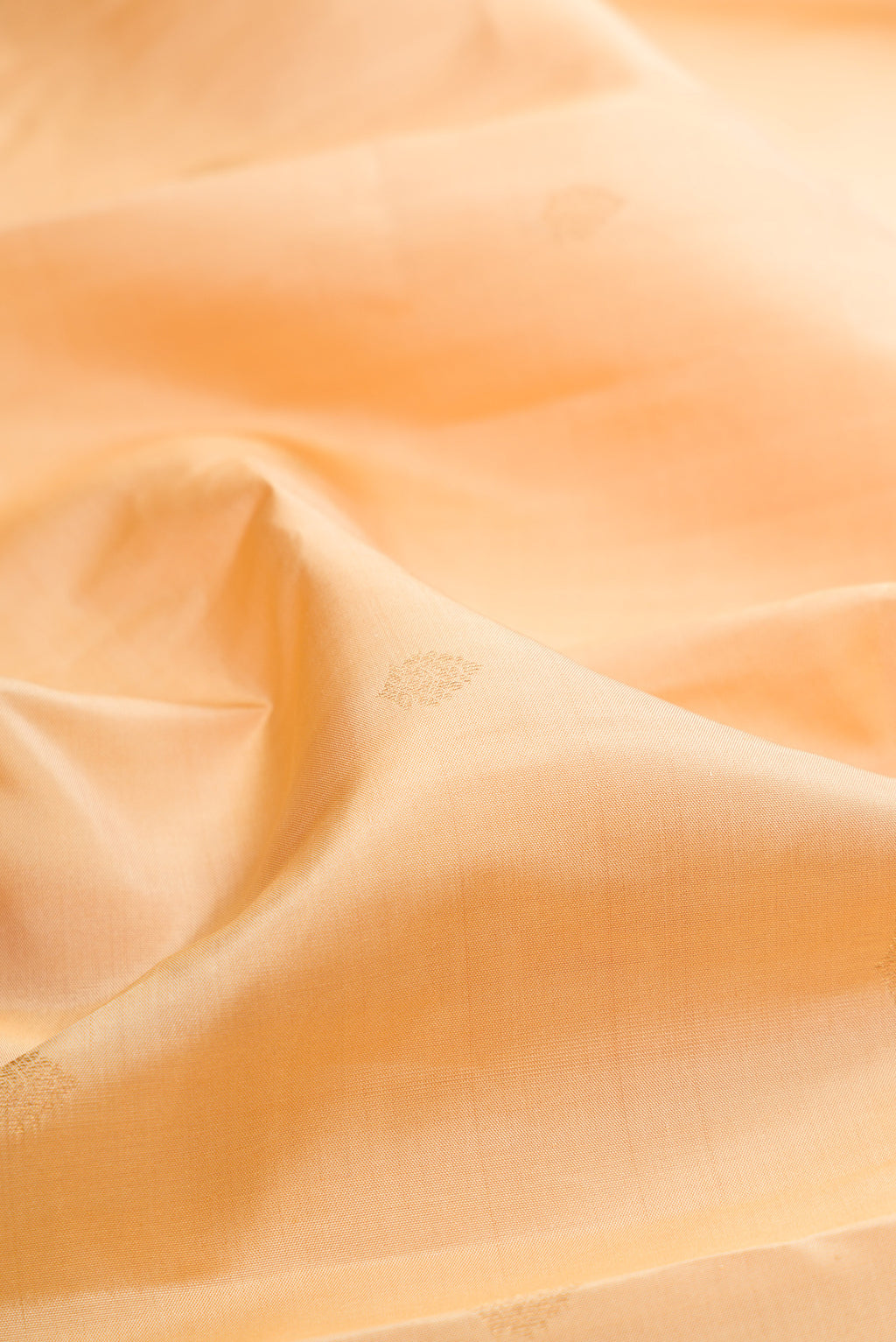 Close up of Sandal Kanchipuram Silk Saree with Zari Butta on the body and Ganga Jamuna Border.  displaying folds