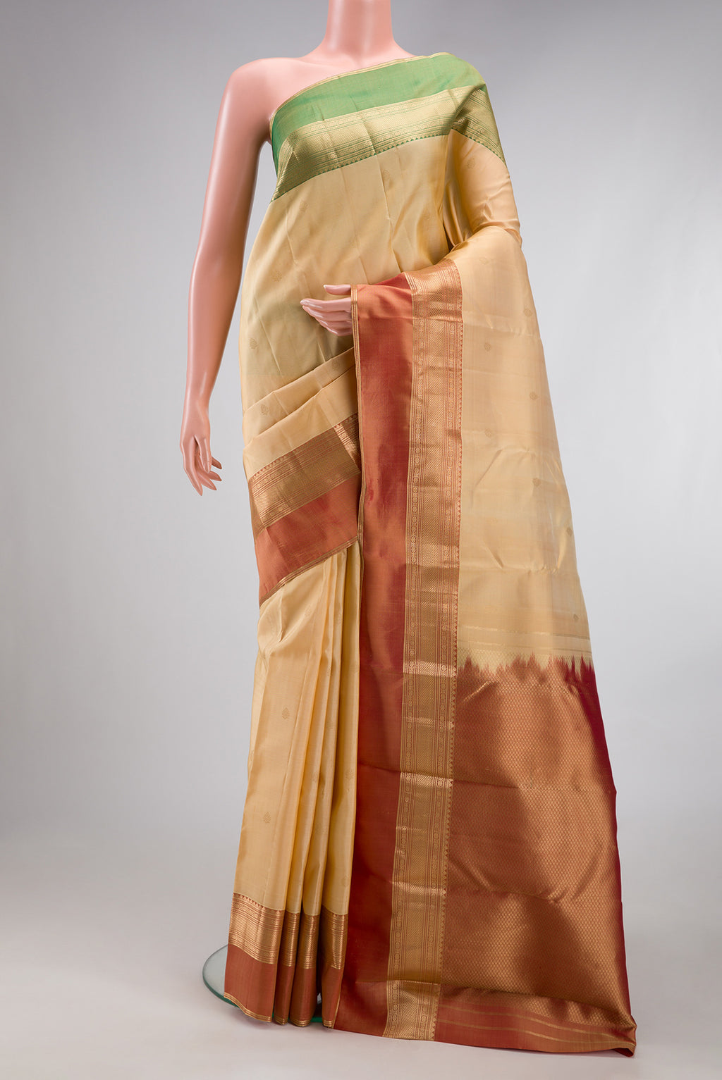 Sandal Kanchipuram Silk Saree with Zari Butta on the body and Ganga Jamuna Border.  displayed on a mannequin
