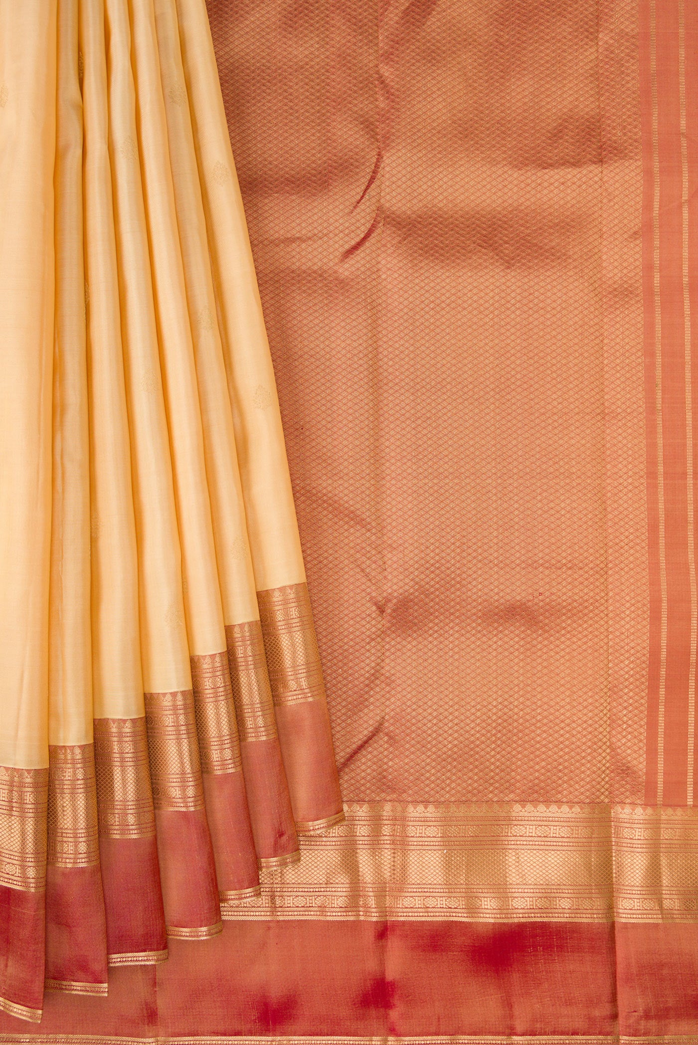 Pleats and pallu of Sandal Kanchipuram Silk Saree with Zari Butta on the body and Ganga Jamuna Border. 